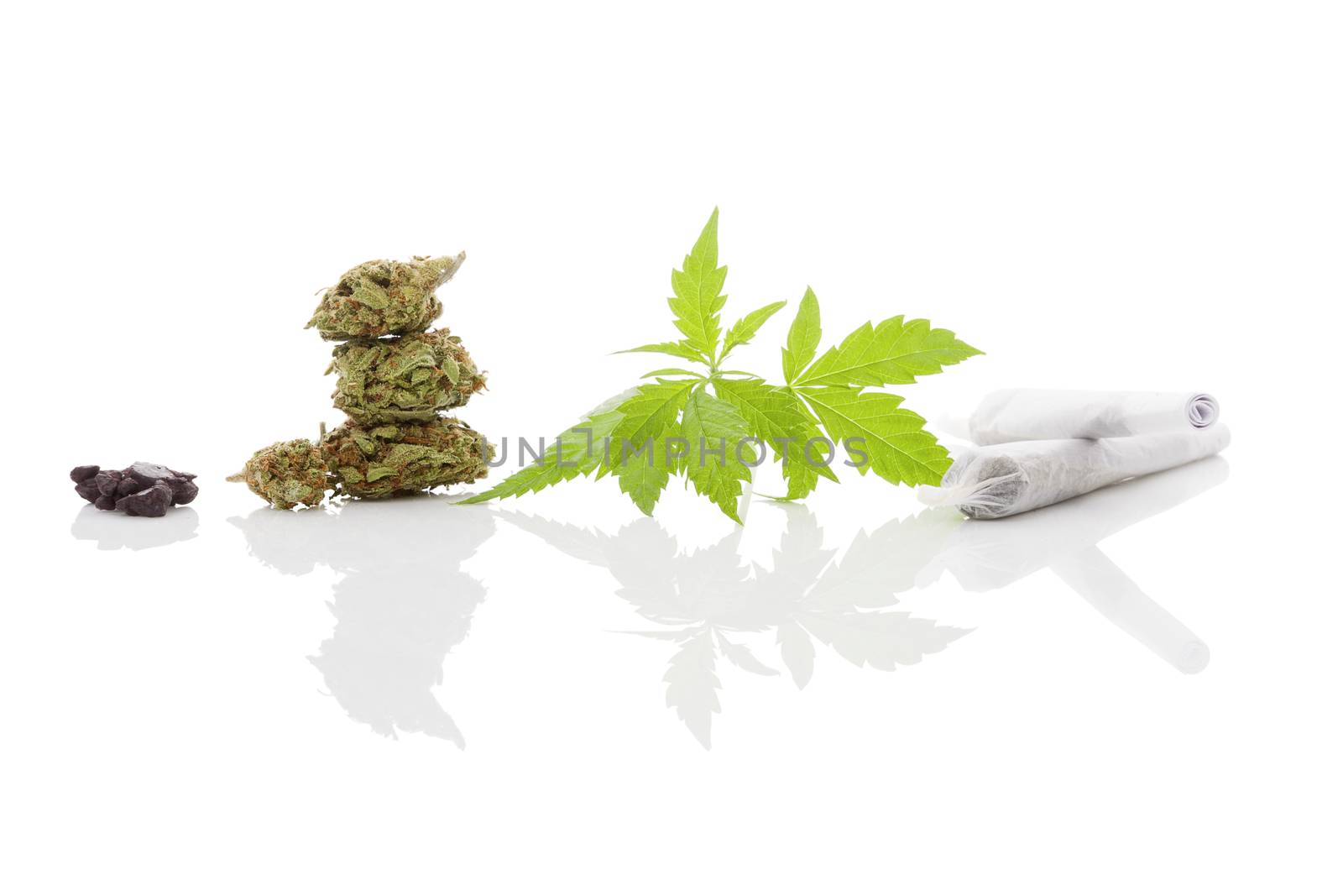 Marijuana cigarette joint, bud, hashish and foliage isolated on white background. Medical marijuana, alternative medicine. 