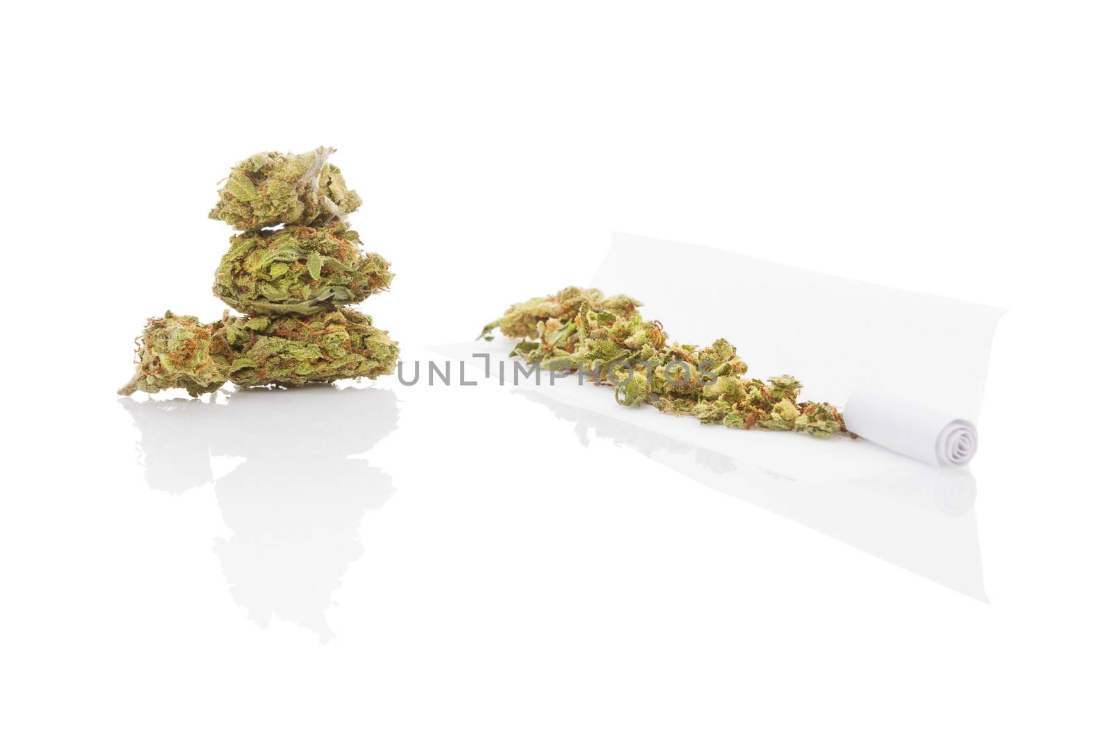 Smoking marijuana. Cannabis abuse. Marijuana bud, hashish, and rolled joint isolated on white background. 