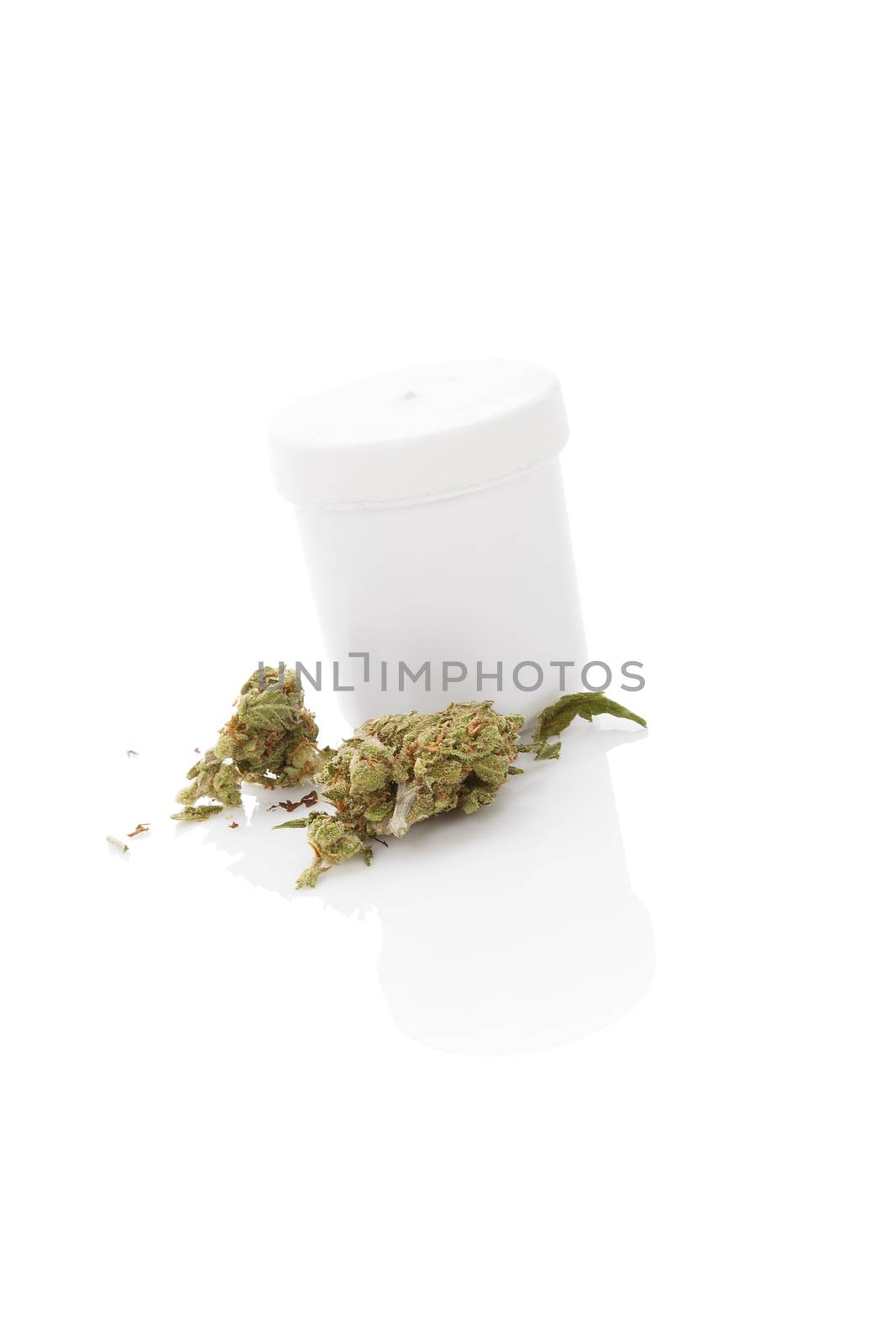 Medical marijuana. Cannabis bud and white container isolated on white background with reflection