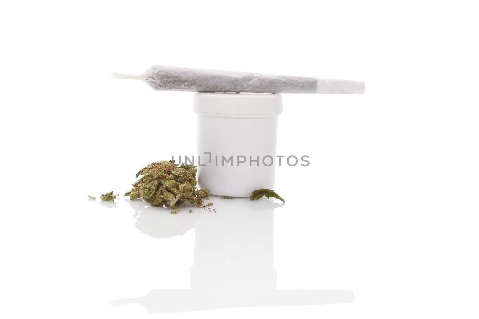 Medical marijuana. Cannabis bud and white container isolated on white background with reflection
