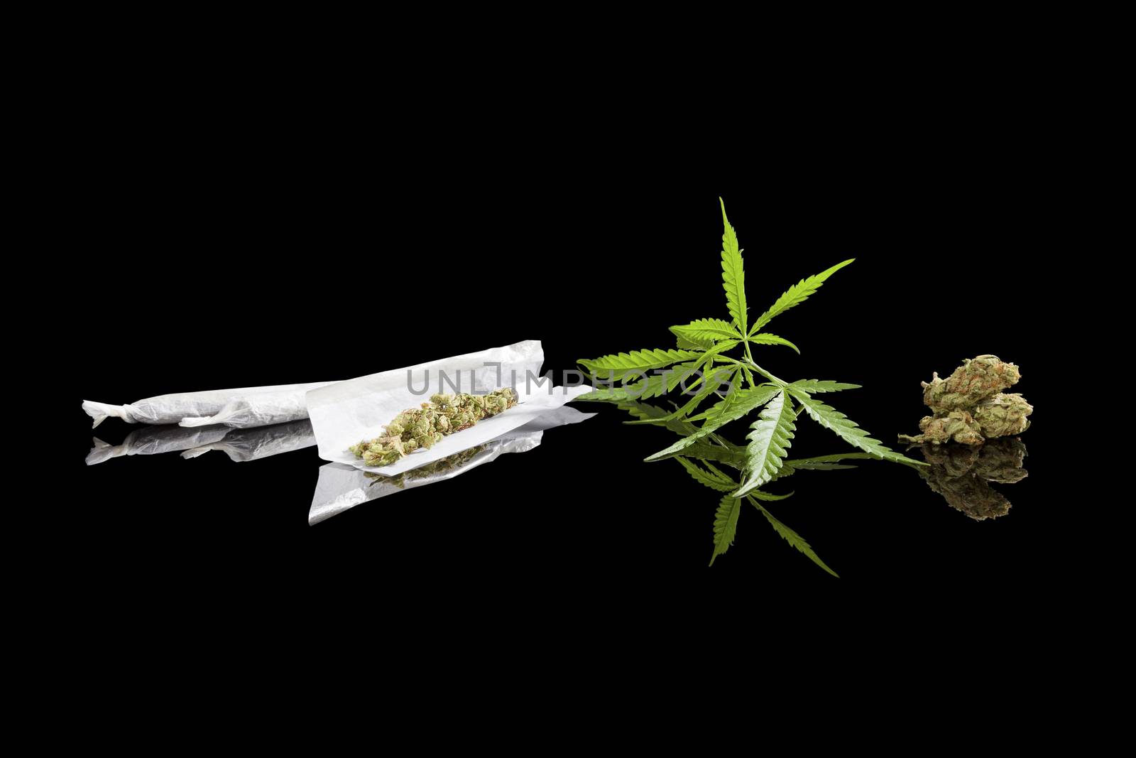 Marijuana background. Cannabis cigarette joint, bud and hemp leaves isolated on black background. Addictive drug or alternative medicine. 