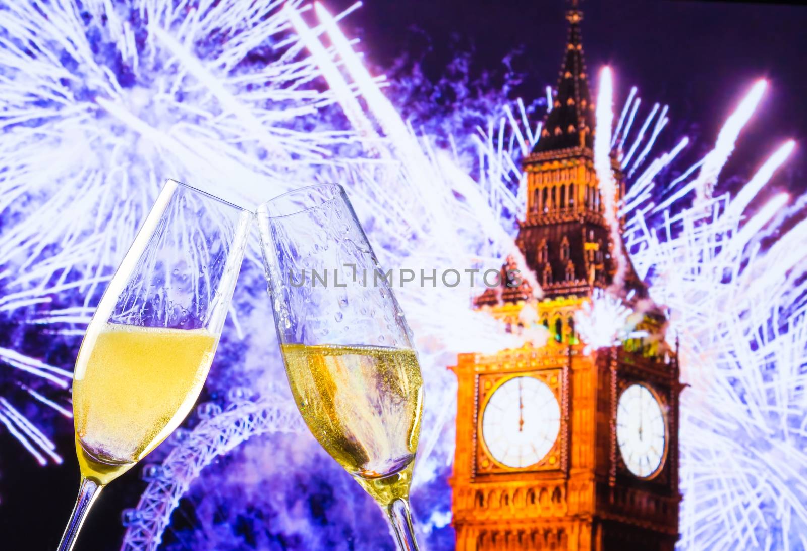 New Year or Christmas at midnight with champagne flutes make cheers on clock and blur background