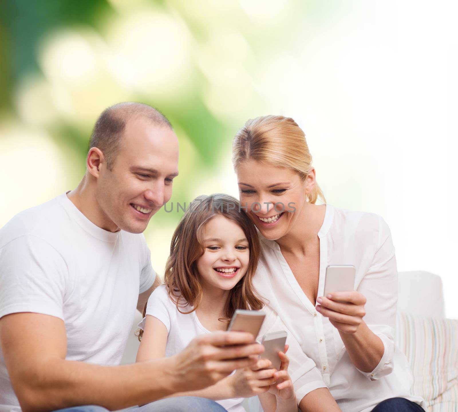 happy family with smartphones by dolgachov