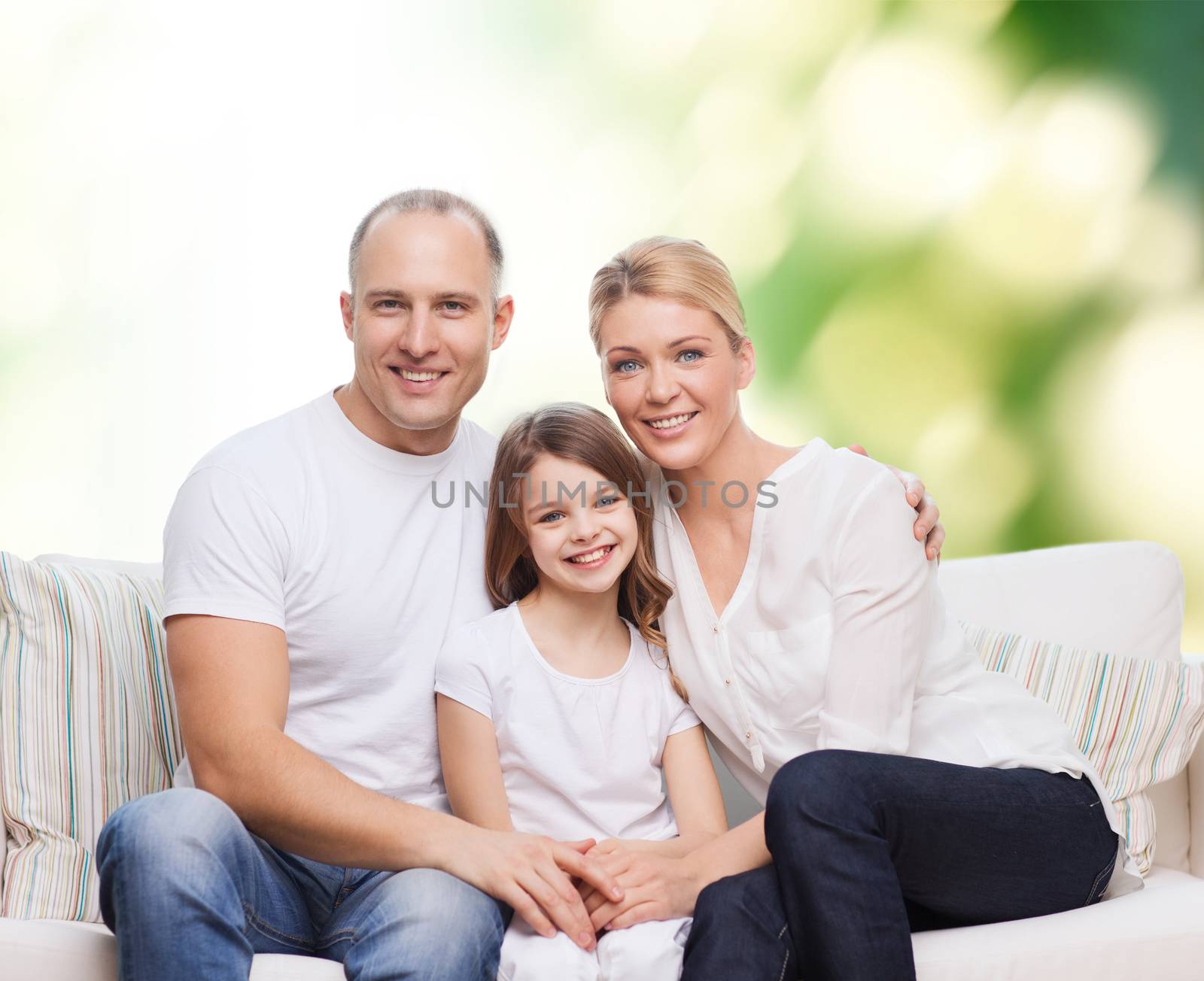 family, childhood, ecology and people concept - smiling mother, father and little girl over green background