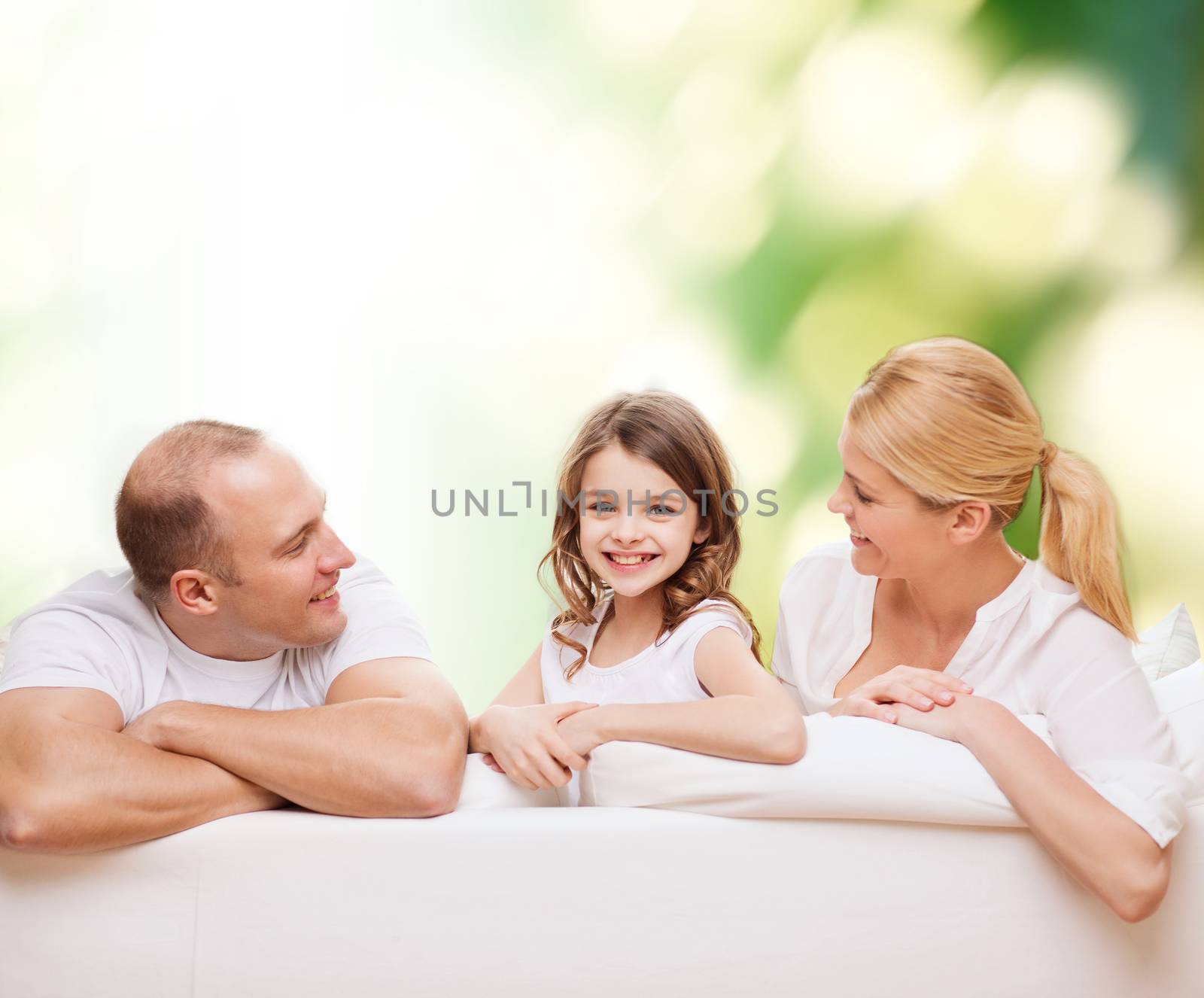 family, childhood, ecology and people - smiling mother, father and little girl over green background