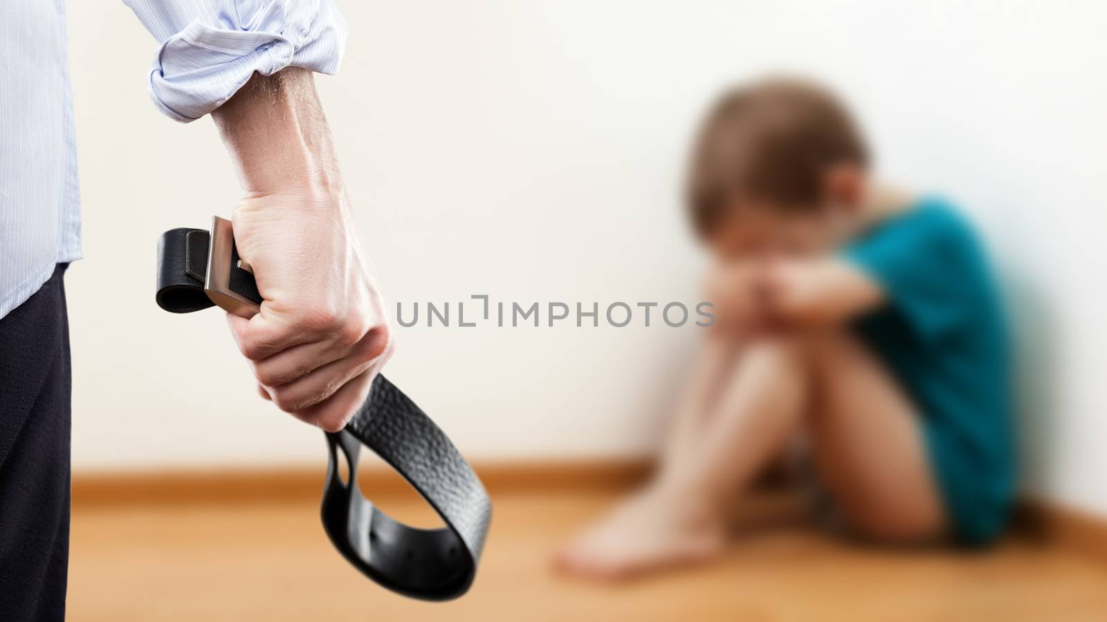 Angry man raised hand holding leather belt over wall corner sitting child boy by ia_64