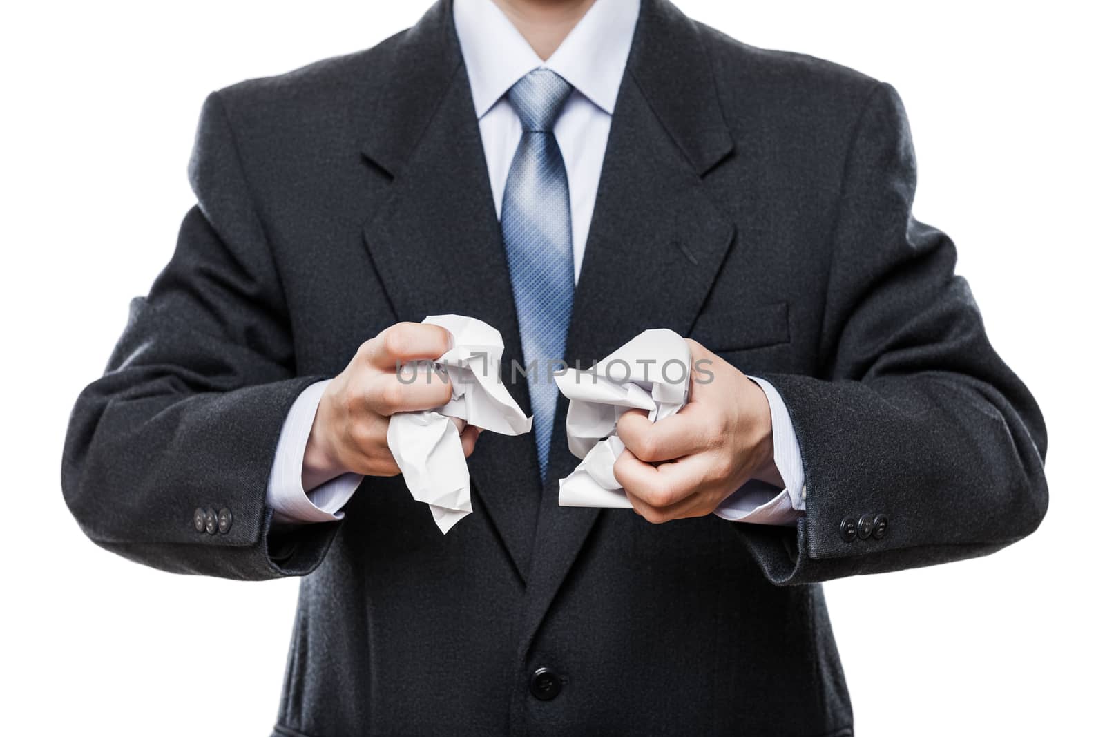 Business problems and failure at work concept - angry businessman in black suit hand holding crumpled torn paper document white isolated