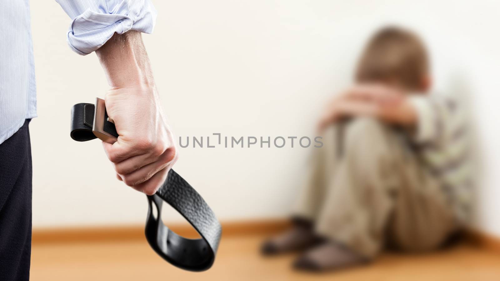Angry man raised hand holding leather belt over wall corner sitting child boy by ia_64