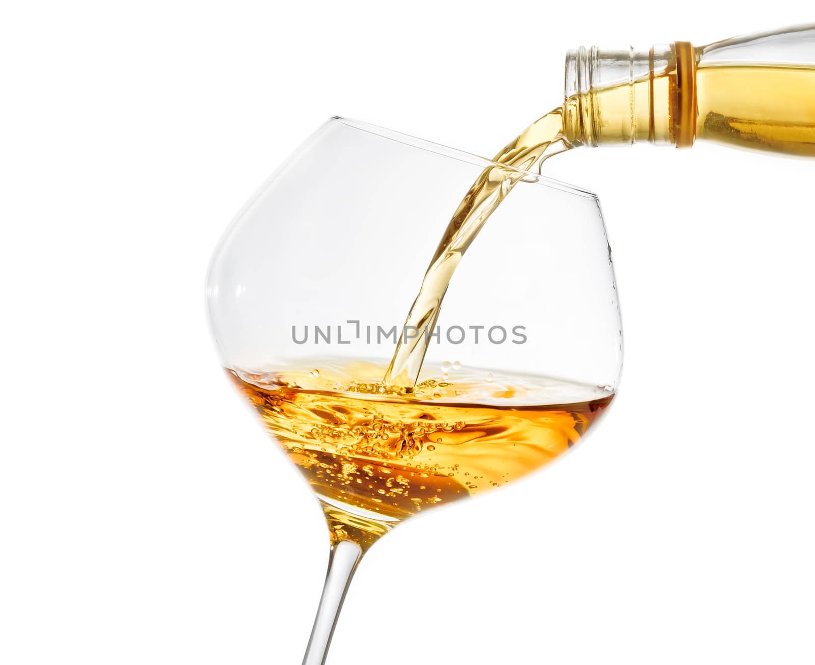 pouring white wine into a glass with space for text by donfiore
