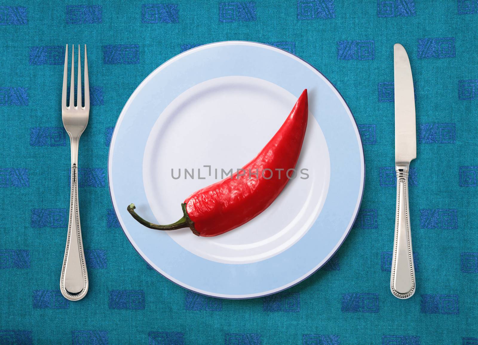 Festive pepper on white plate with knife and fork