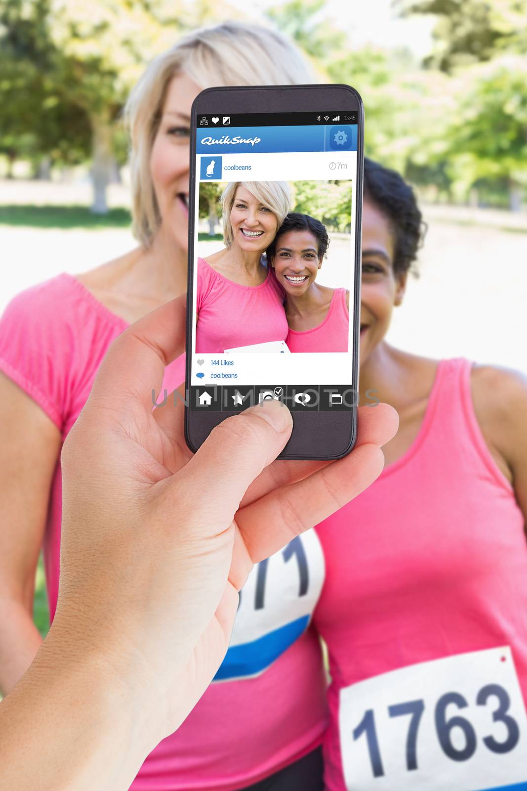 Female hand holding a smartphone against photo sharing app