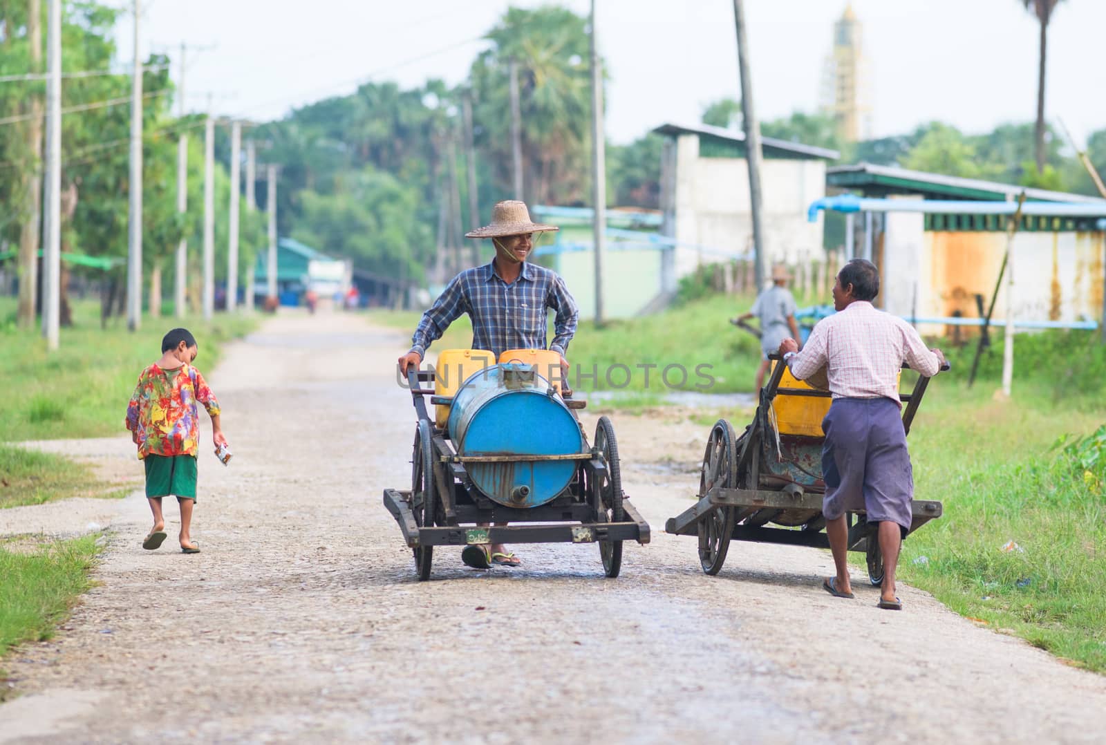 Labutta Township, Myanmar - September 25, 2015: Many towns in Myanmar lack a public water supply. In Labutta, a town in the Ayeyarwady Division, vendors get water at a pump station for distribution to customers downtown.