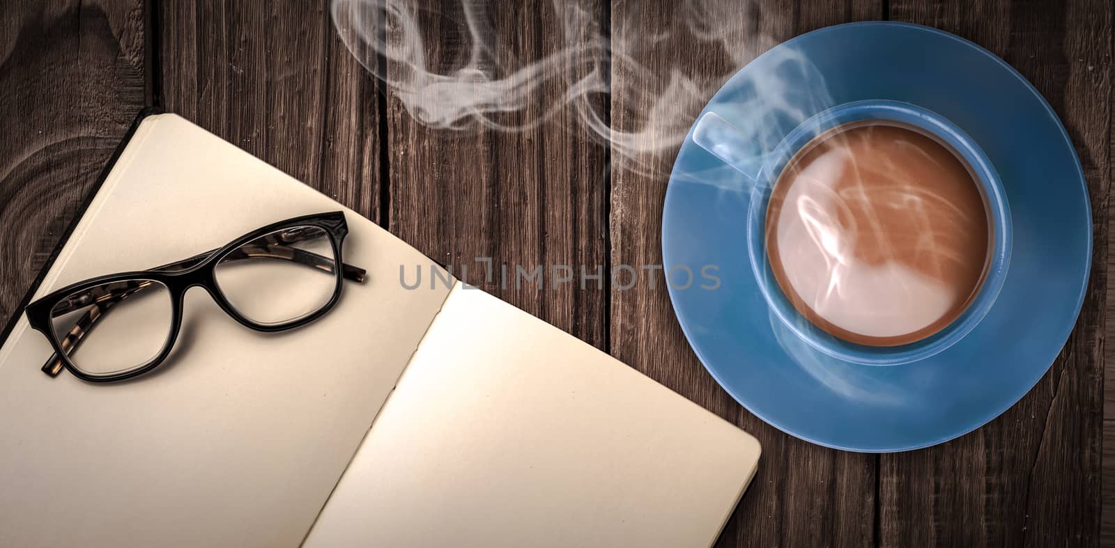 Overhead view of hot tea by hand writing on book by Wavebreakmedia