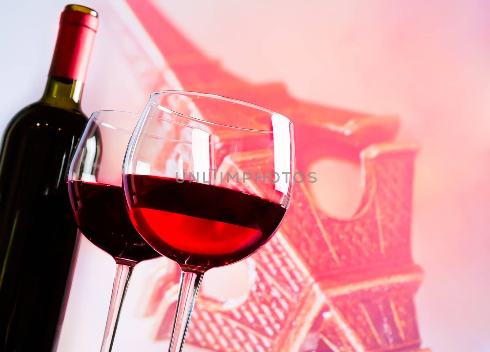 two red wine glasses on blur tower Eiffel background, festive and love concept