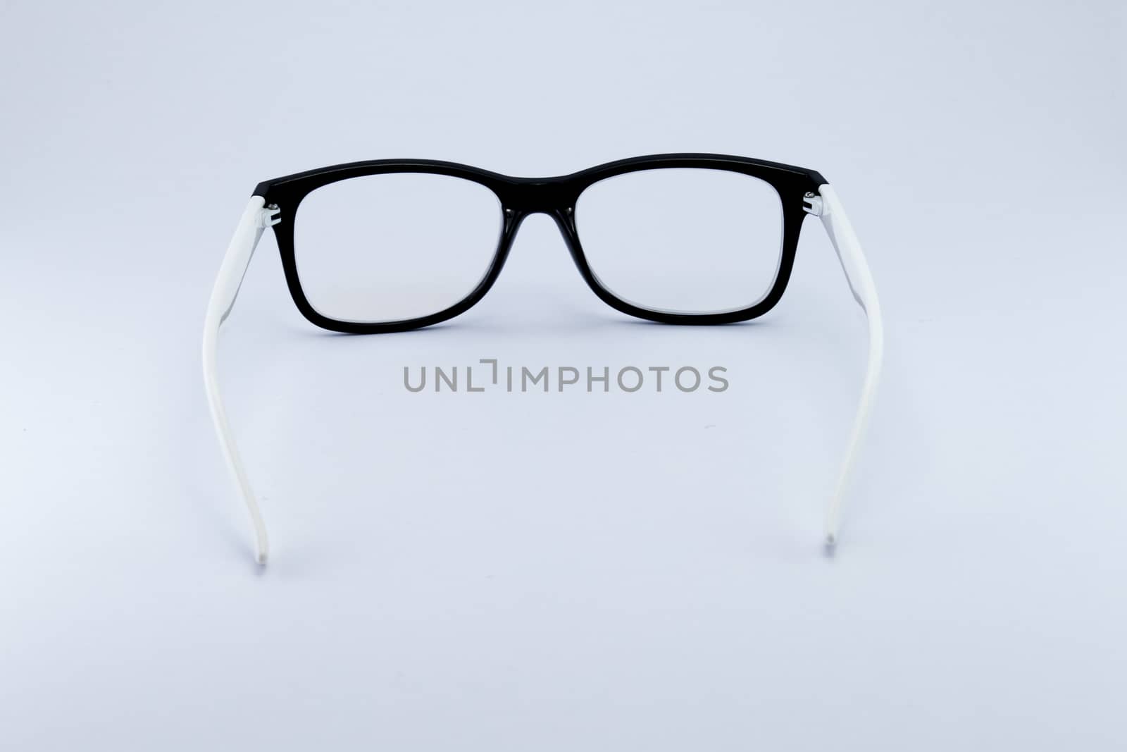 Black glasses to improve eyesight isolated on white background by teerawit