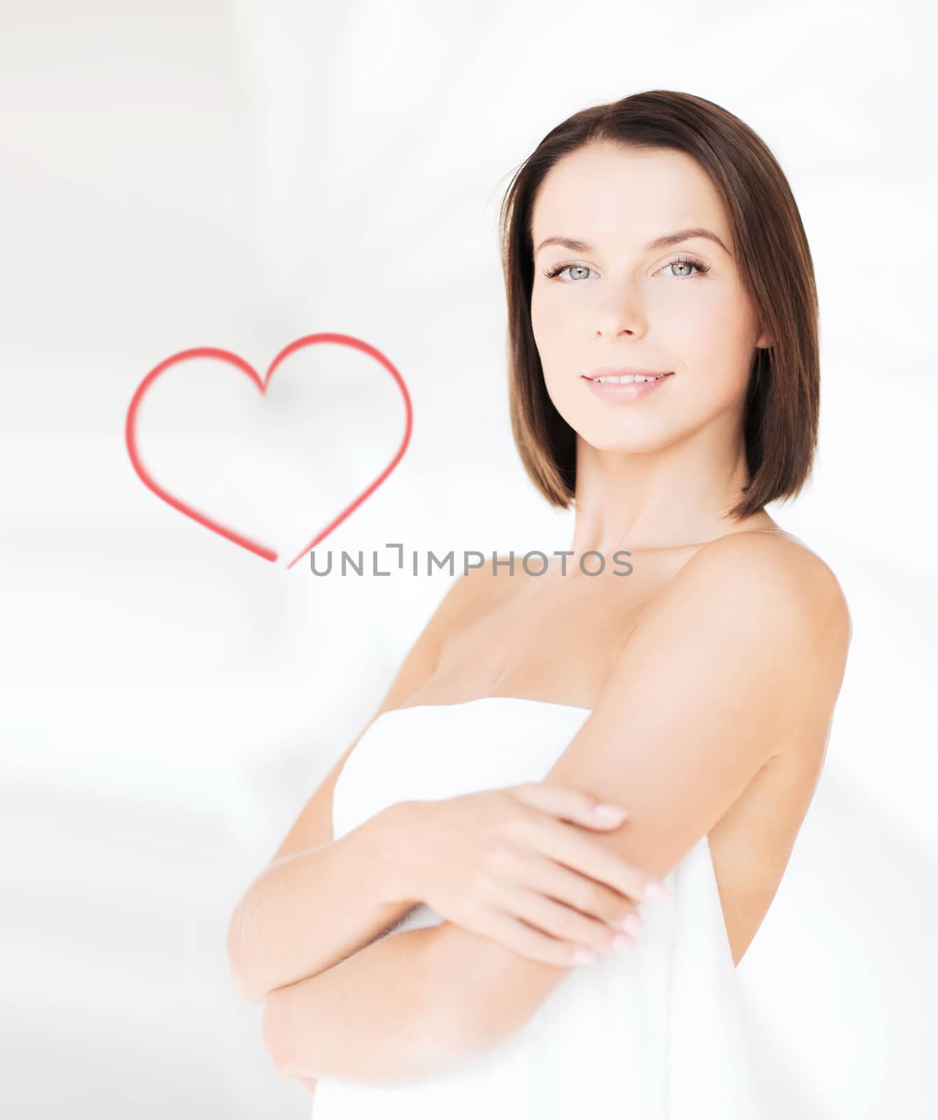 beauty, spa and people concept - beautiful woman standing in towel