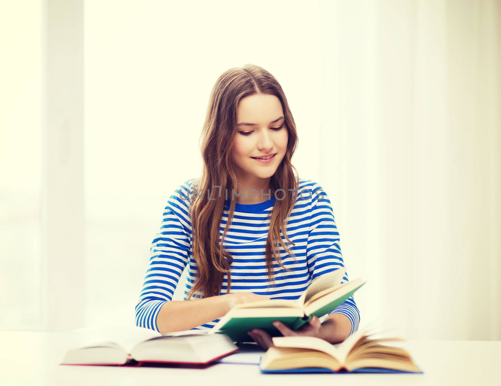 happy smiling student girl with books by dolgachov