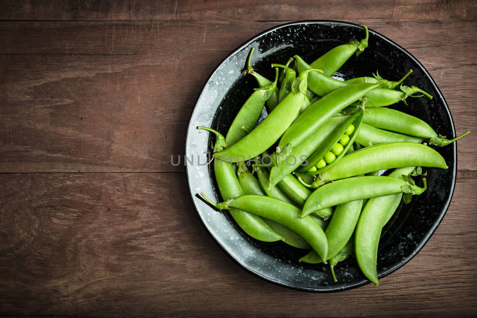 Fresh peas on woodden background