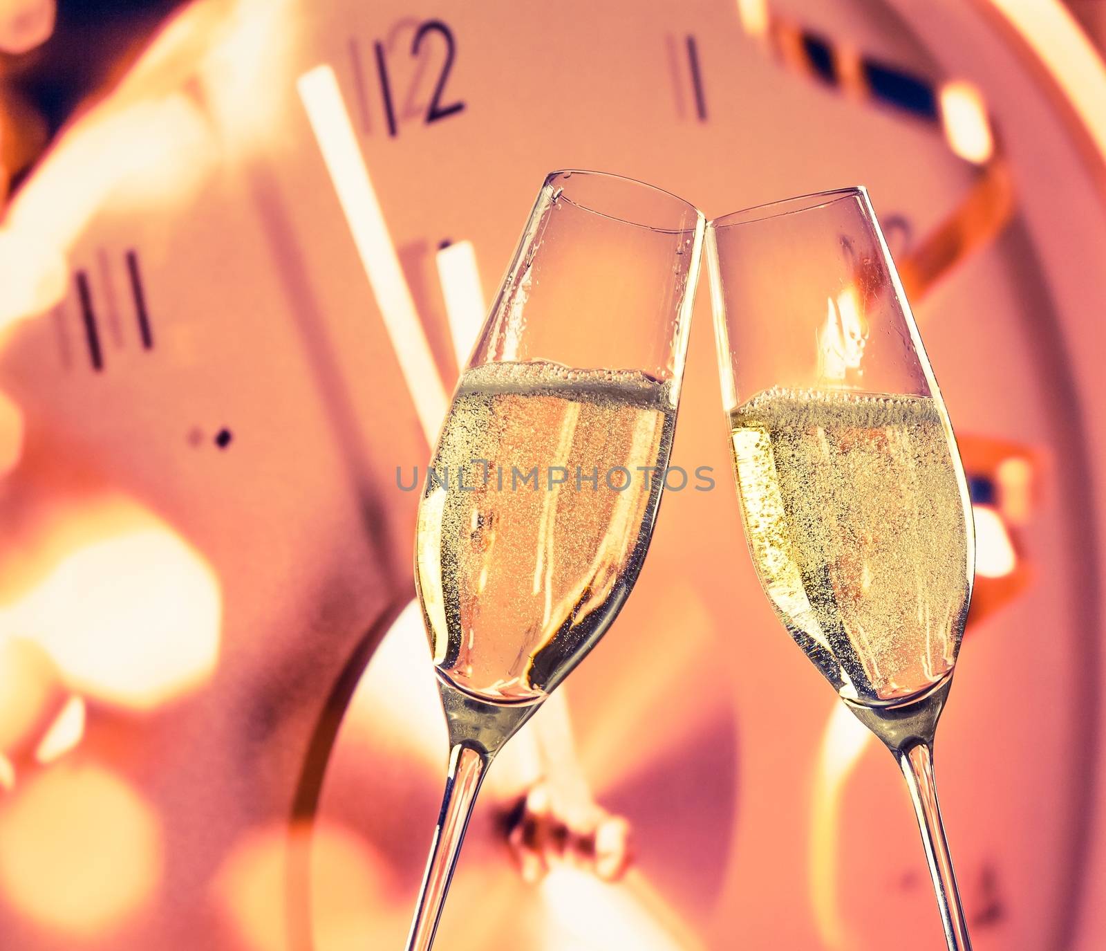 New Year or Christmas at midnight with champagne flutes make cheers on clock background by donfiore