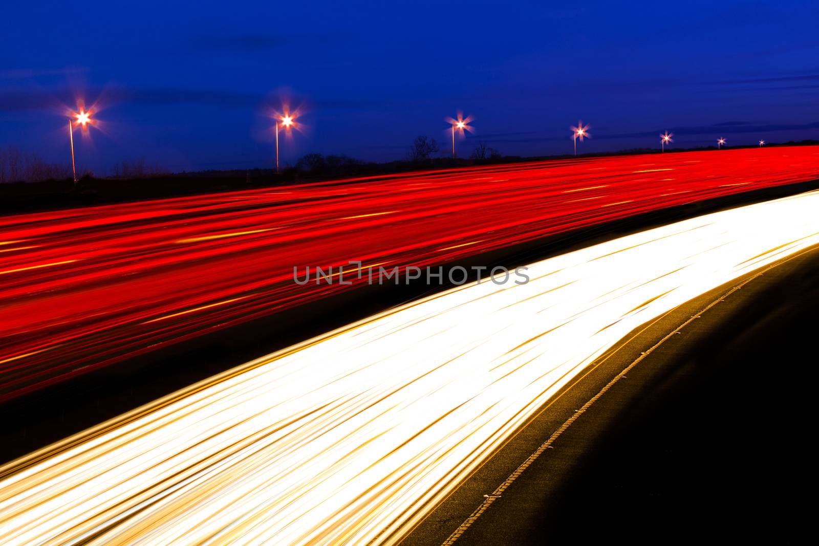 Long exposure shot of cars and lorries leaving light trails as they pass by quickly 