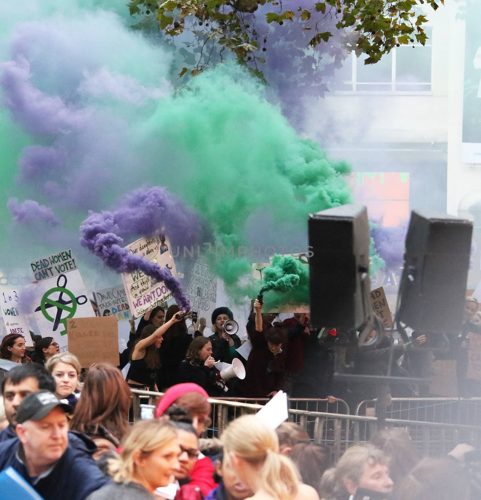 UNITED KINGDOM, London: Feminist protesters hold posters and release green and purple smoke bombs to highlight cuts to domestic violence services during the screening of Suffragette on opening night of the BFI London Film Festival at London's Odeon Leicester Square on October 7, 2015. 