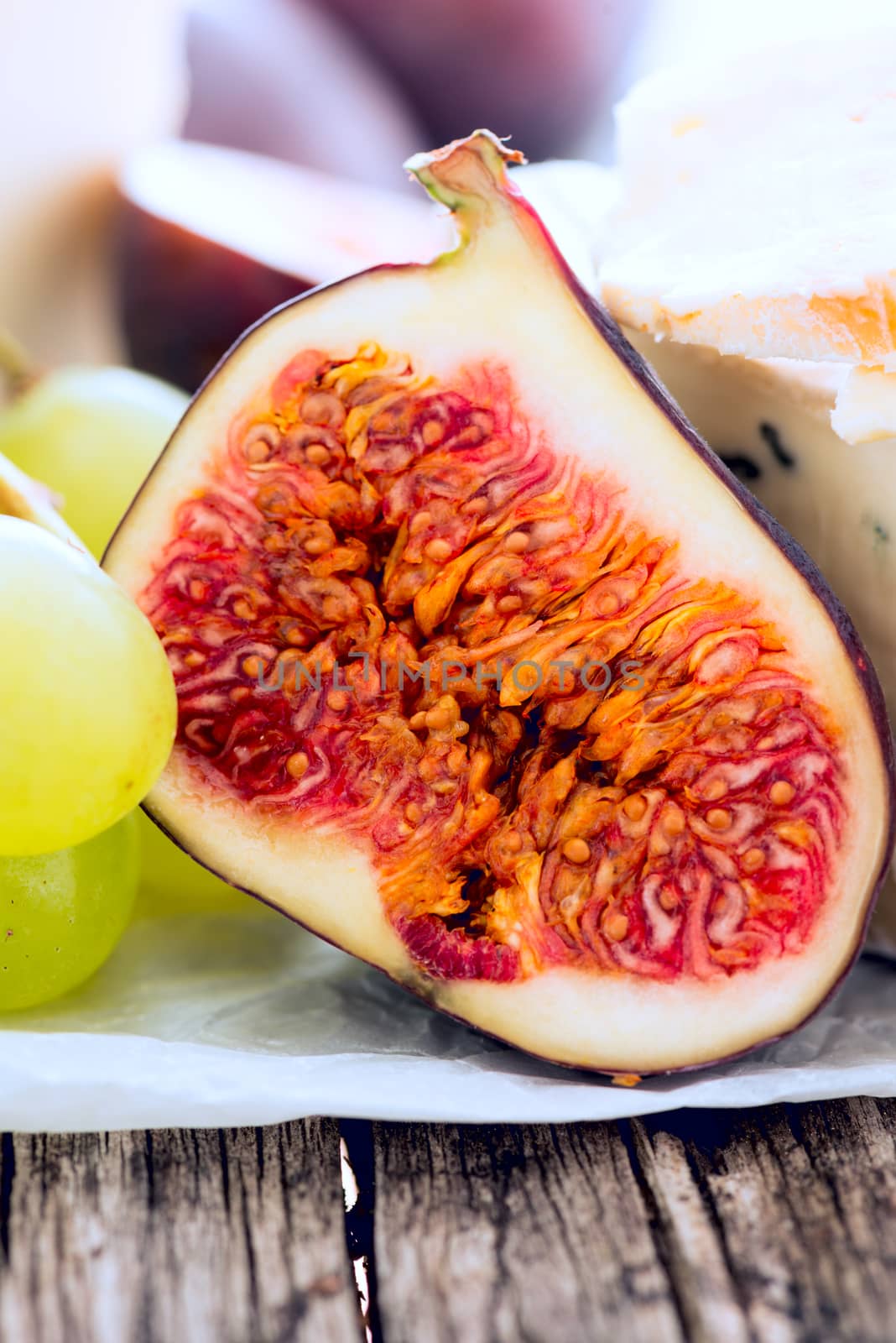 Delicacy cheese and fruit plate on table, closeup