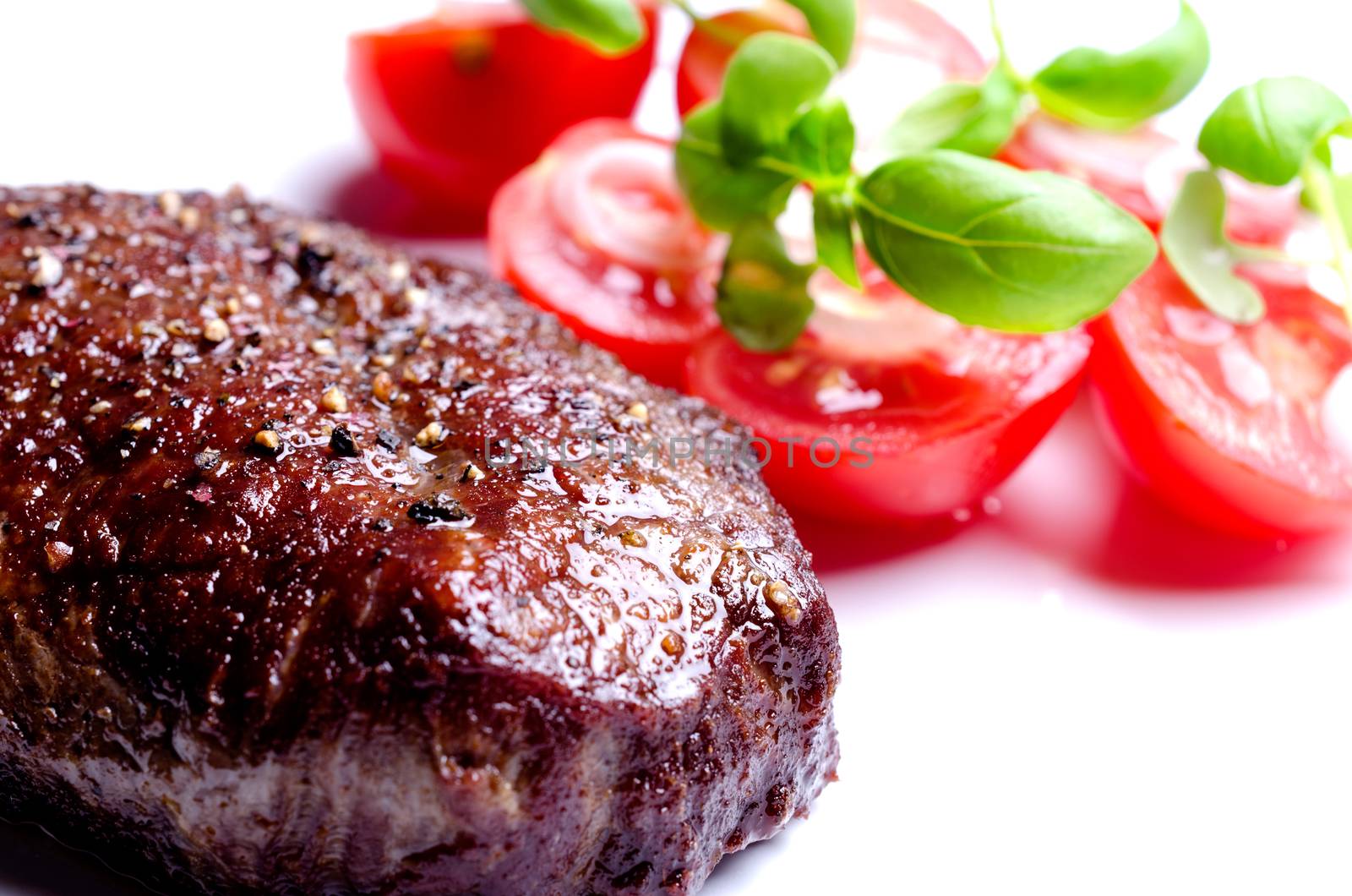 Grilled steak with tomatoes and oregano leafs by Nanisimova