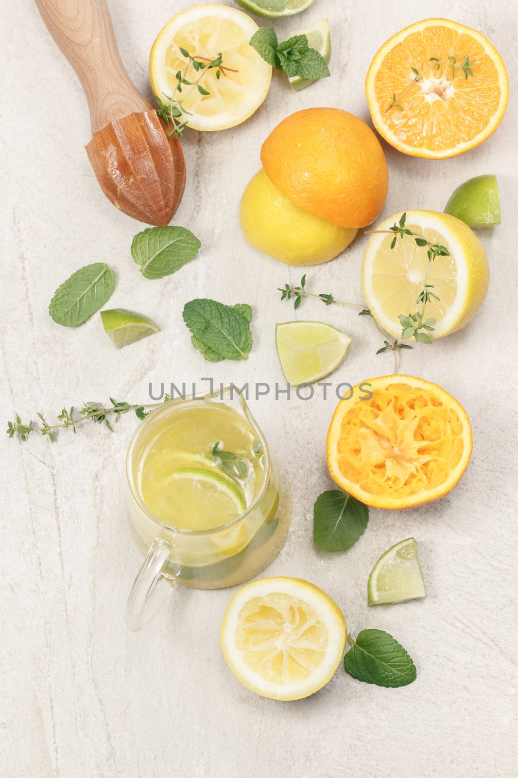 Still life with citrus fruits and wooden citrus squeezer on granite table, top view. Macro, selective focus,