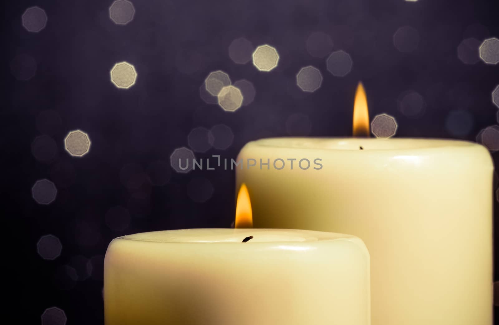 close-up of candles with flame on bokeh by donfiore