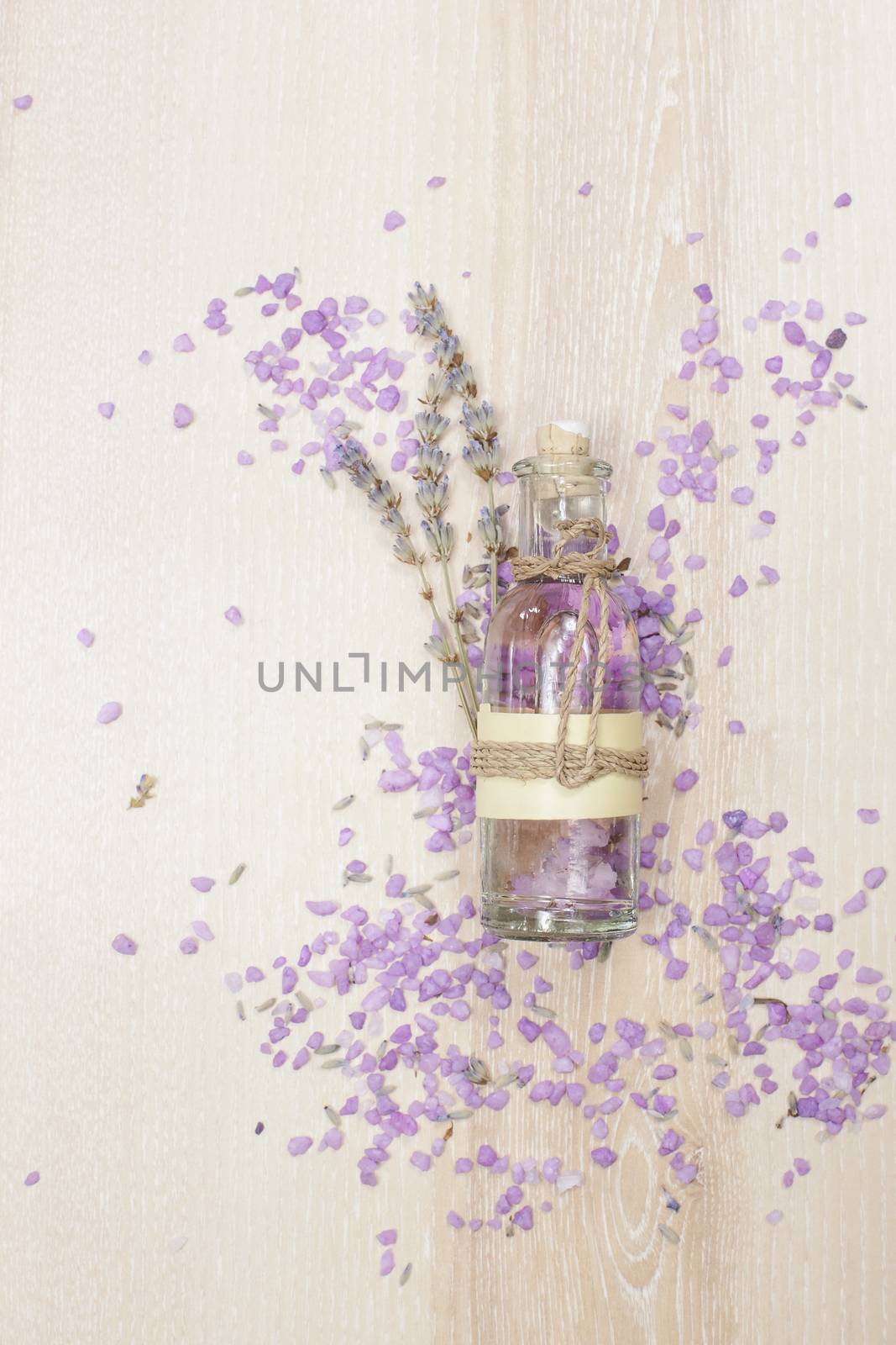 Aromatherapy lavender bath salt and massage oil on wooden background