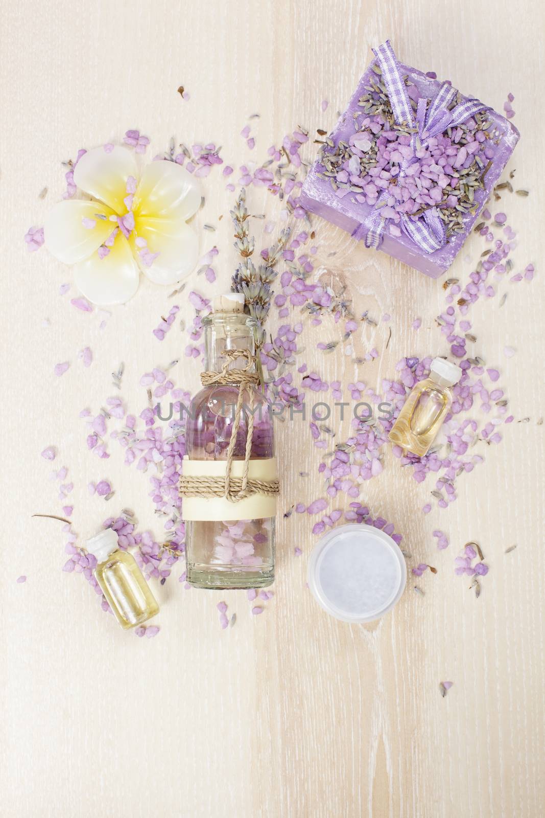 Various lavender beauty products on the wooden board.