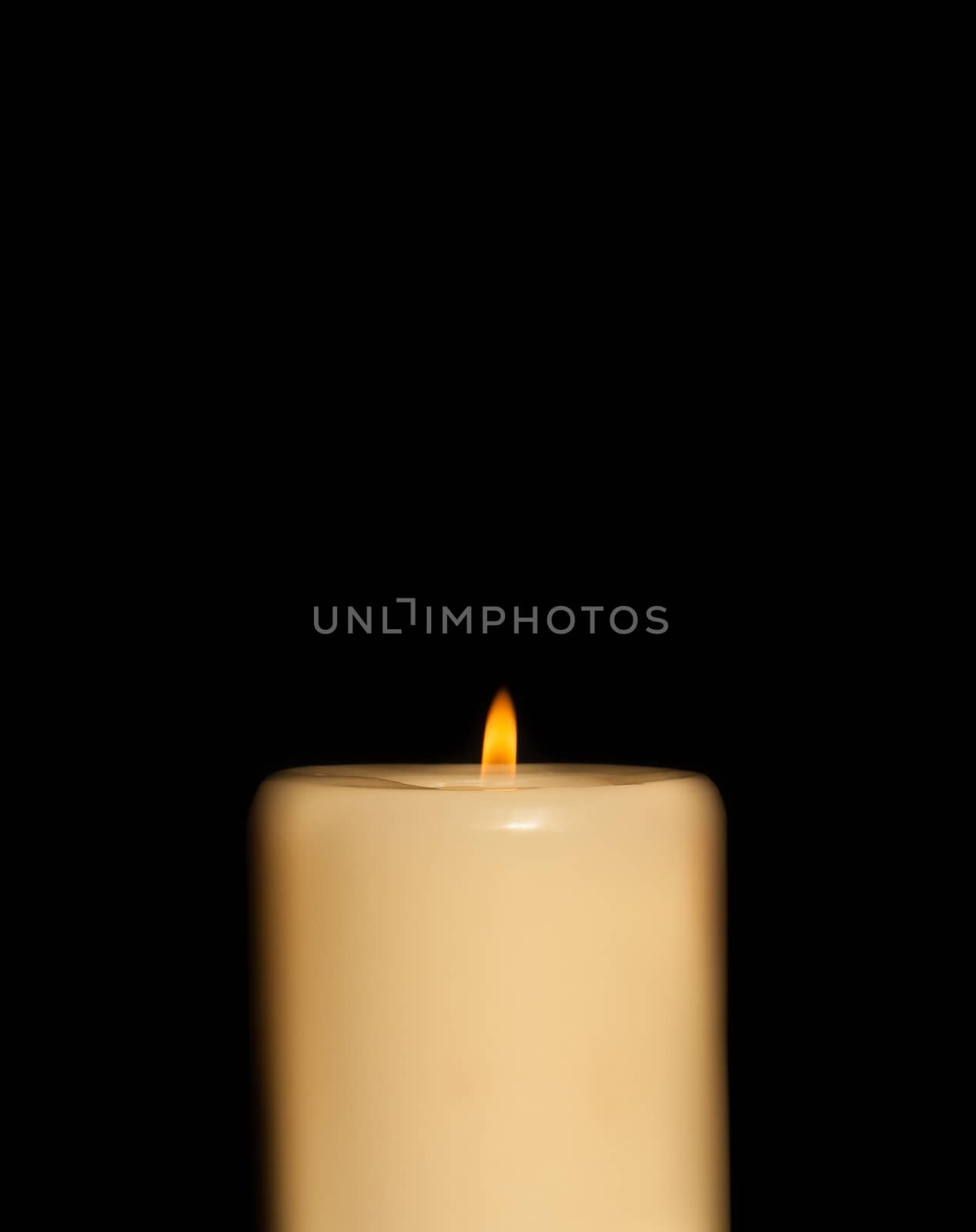 candle with flame and black background and space for text
