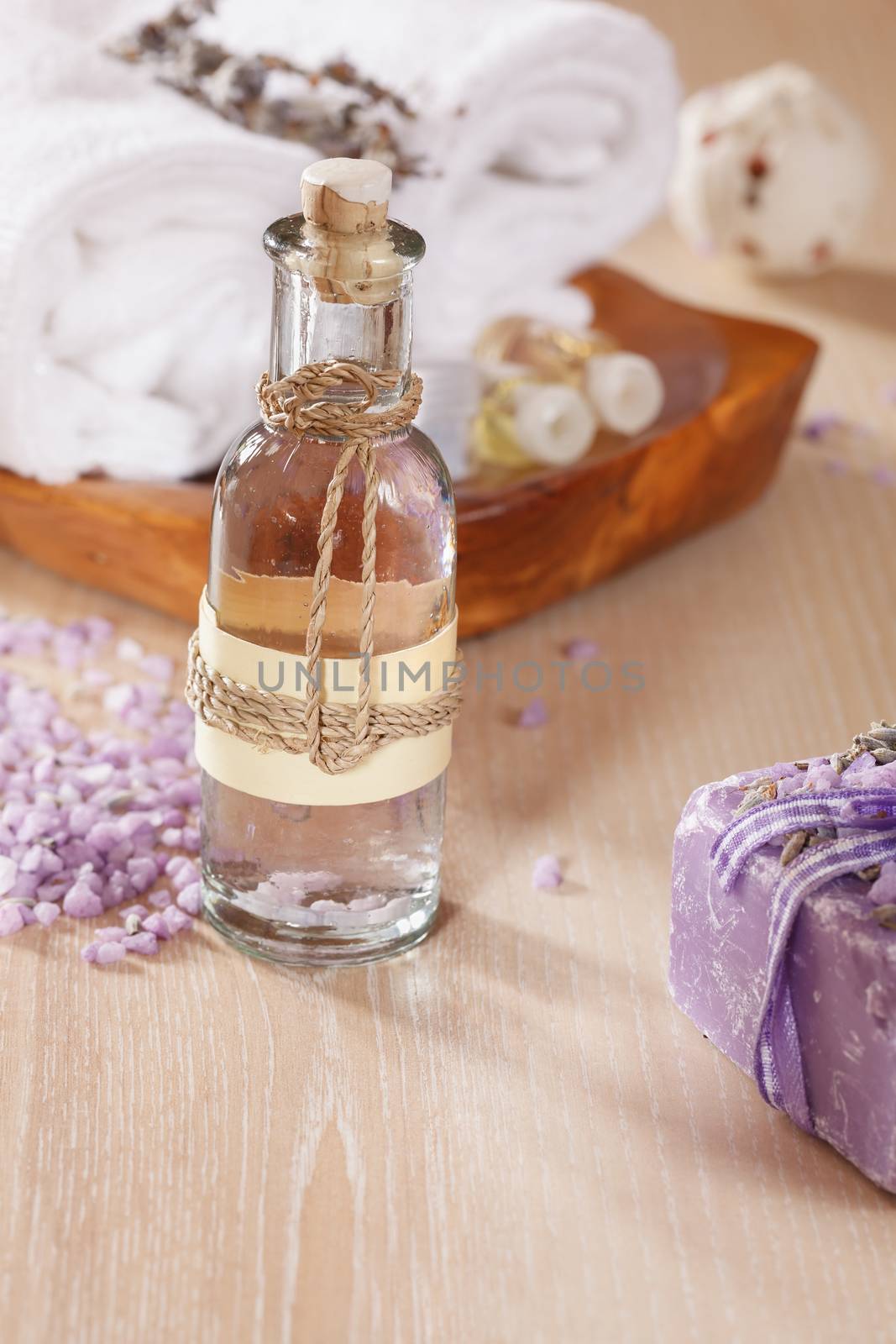 Various objects and beauty products on the wooden board. A macro photograph with shallow depth of field.