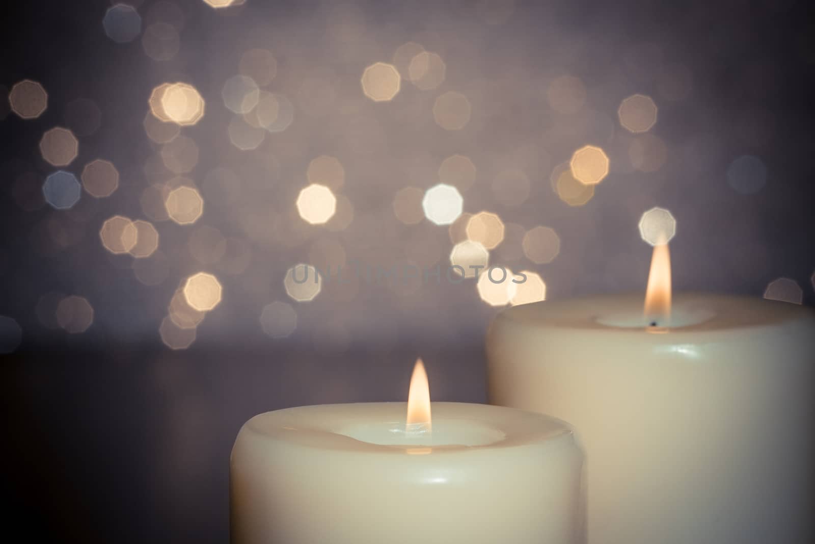 close-up of candles with flame on bokeh background and space for text