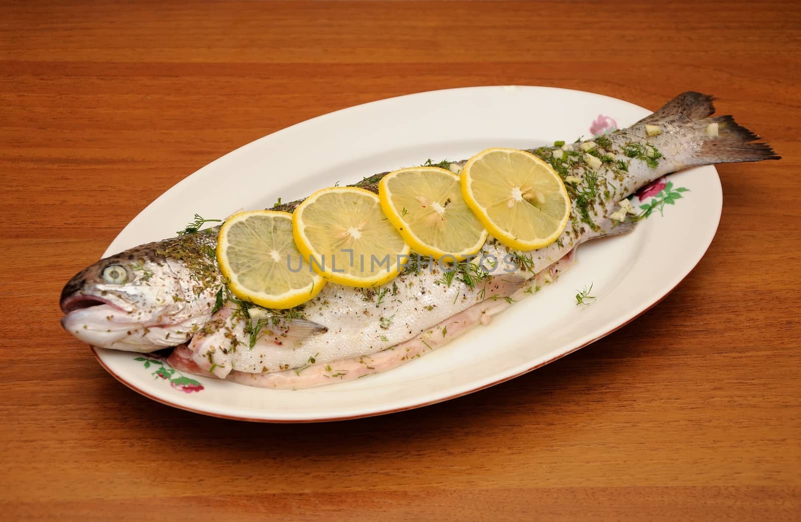 fresh rainbow trout with spices and lemon ready for coocking