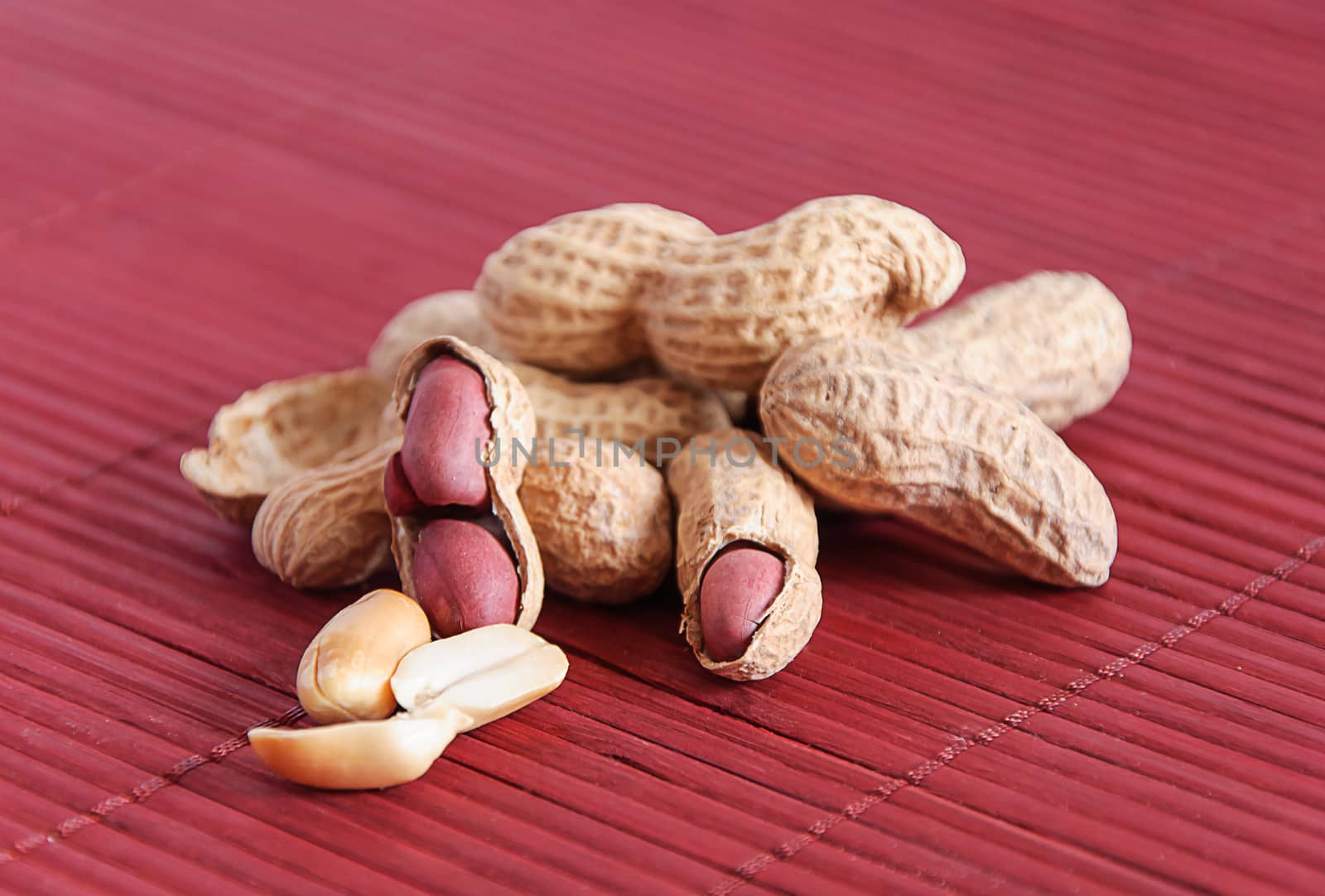 Peanuts in shels on violet pad, stock photo