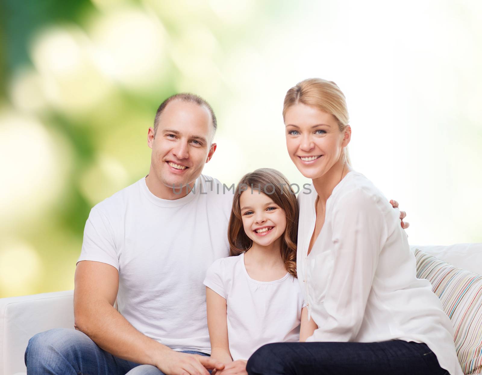 family, childhood, ecology and people - smiling mother, father and little girl over green background