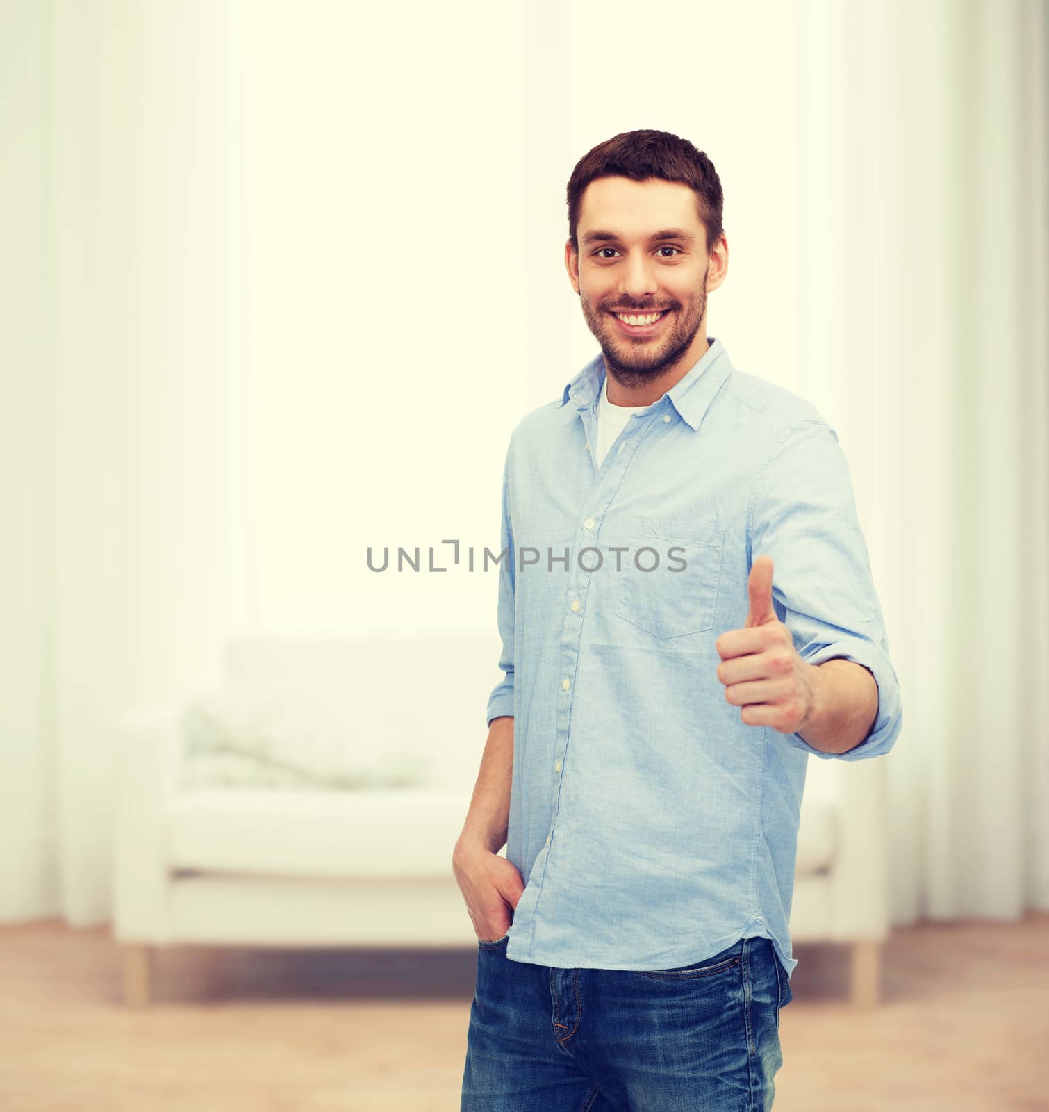 happiness, gesture and people concept - smiling man showing thumbs up