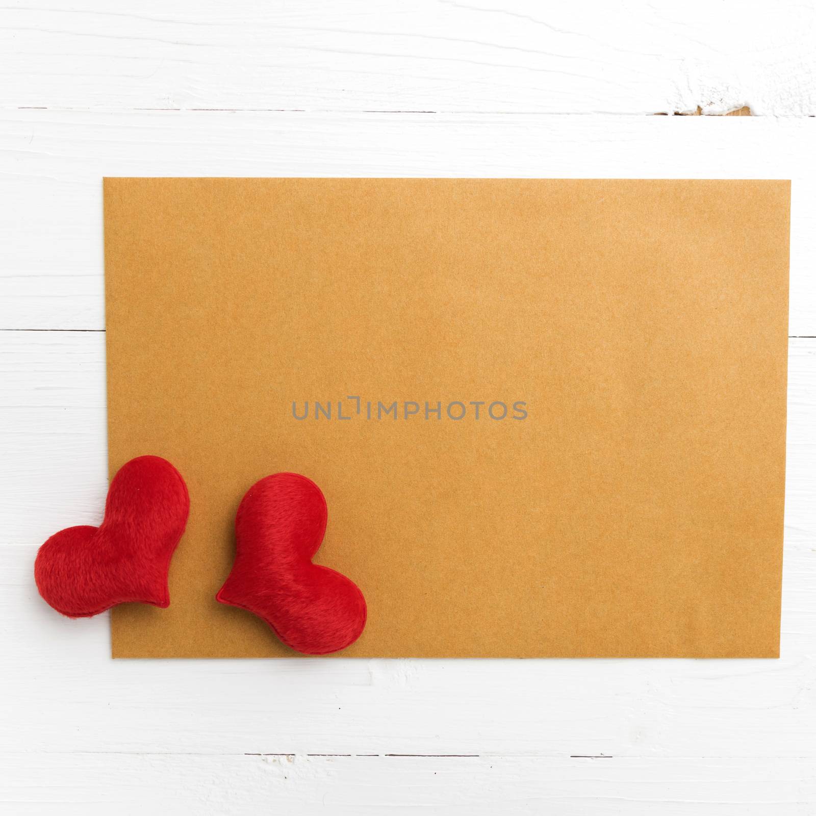 brown paper and heart on white table