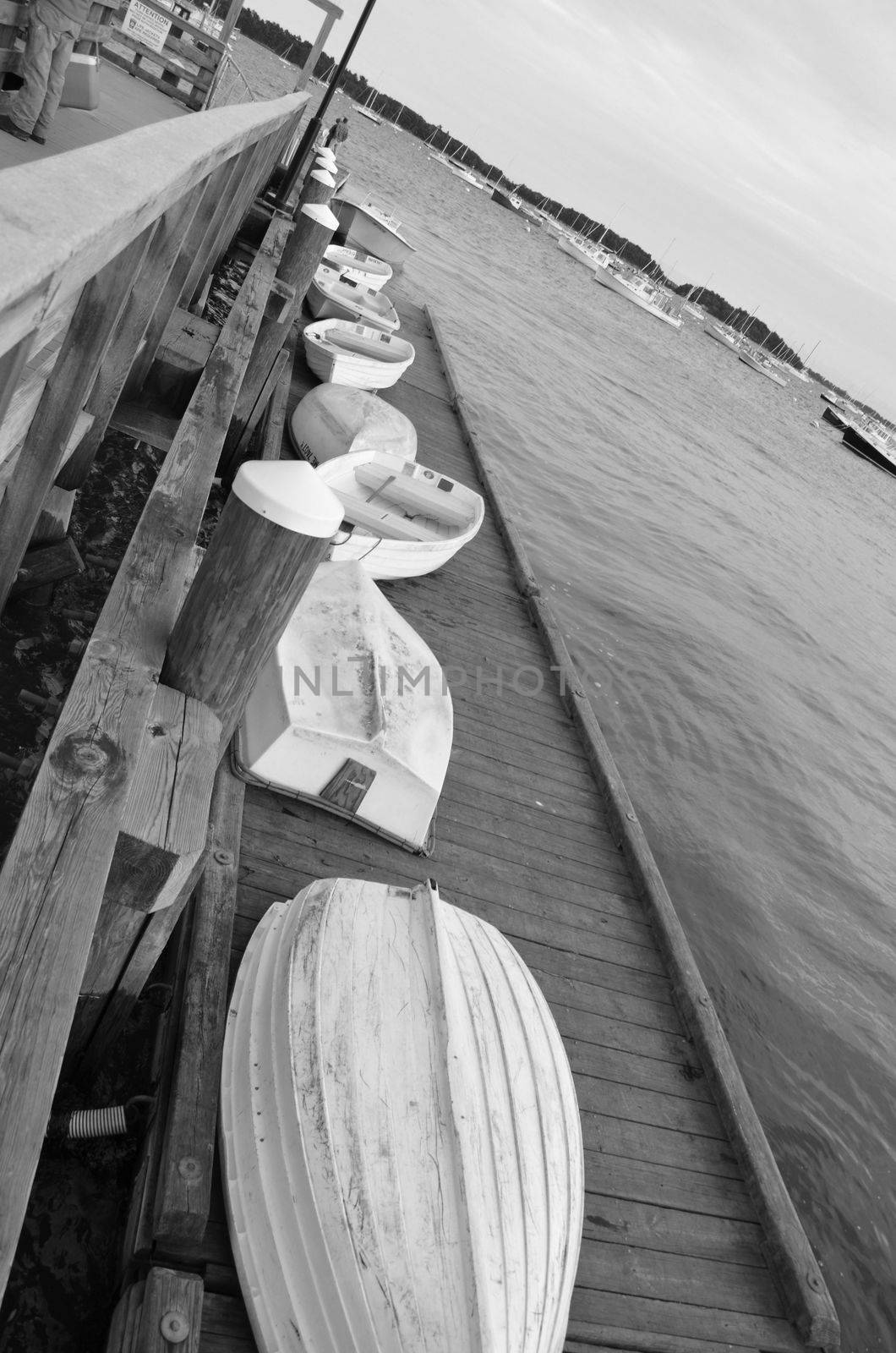 Boats along the dock in Falmouth Maine. Shown in black and white.