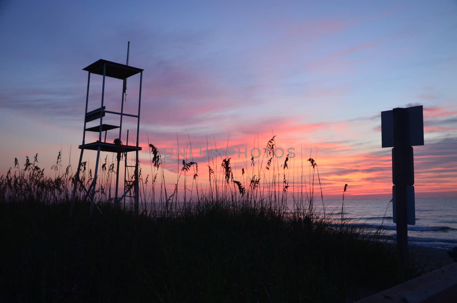 An empty lifegaurd stand seen during sunrise at Kure Beach North Carolina on a warm summer morning.