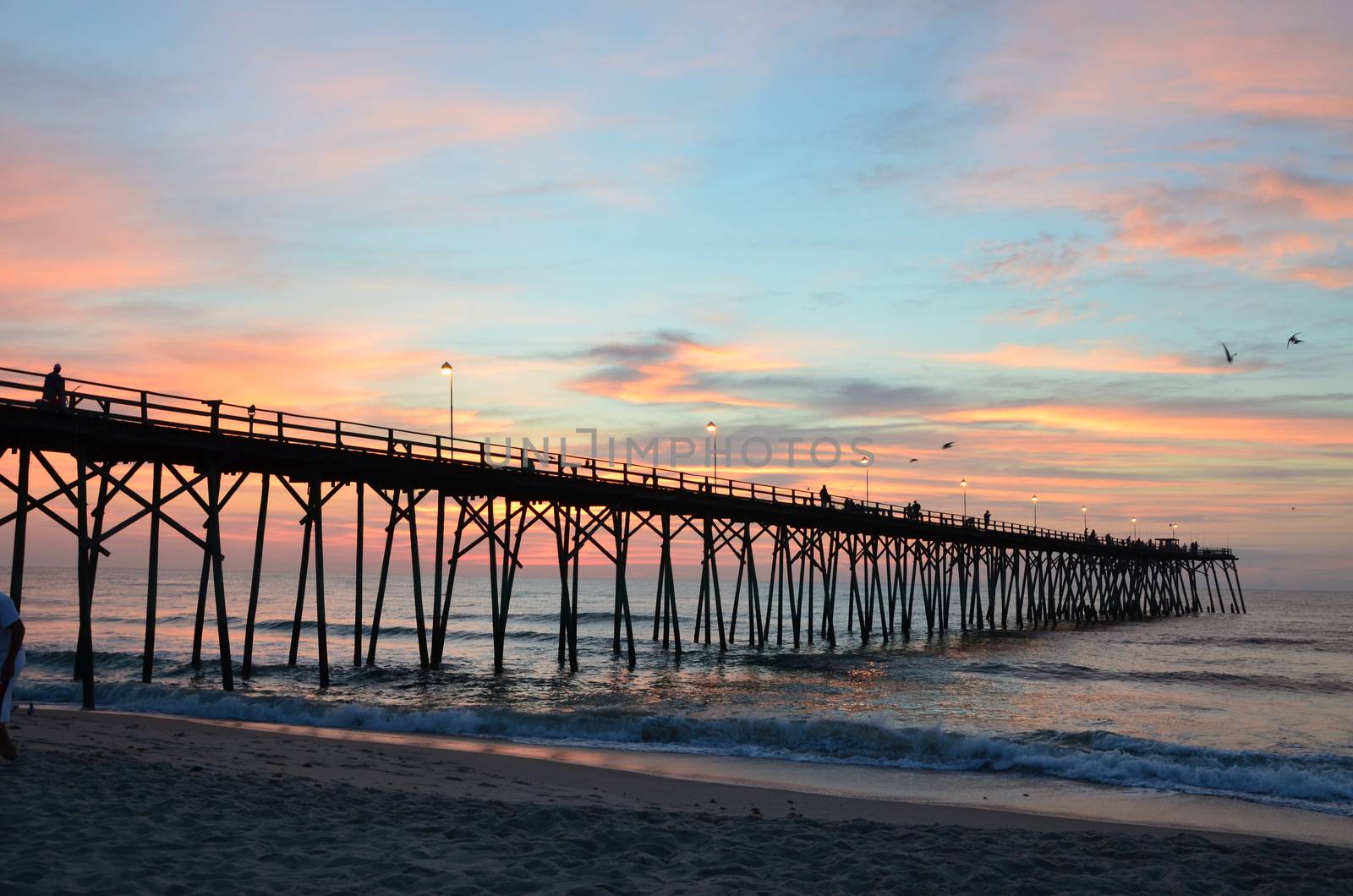 Sunrise at Kure Beach North Carolina on a warm summer morning. Seen rom near the pier.