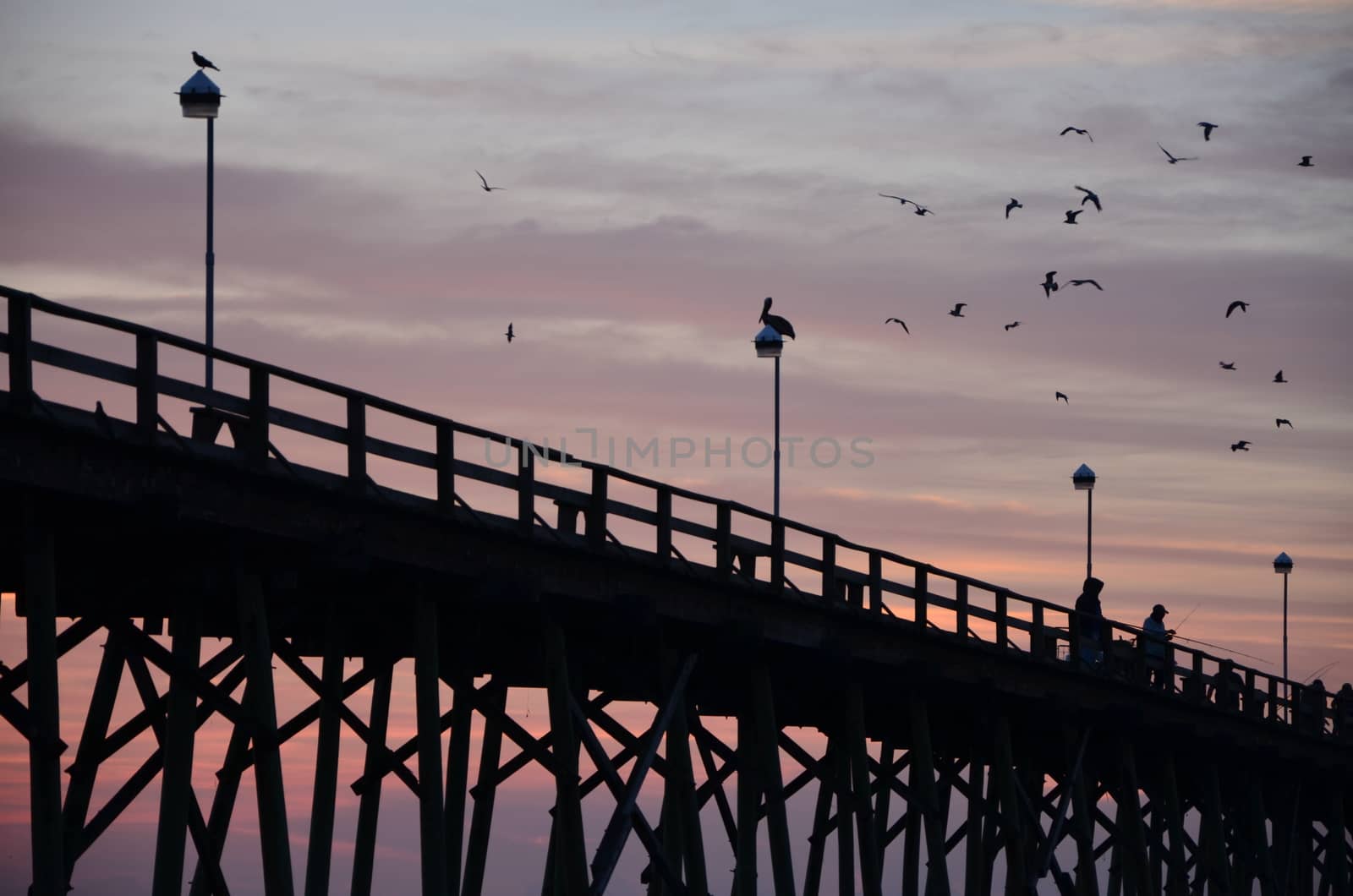 Sunrise at Kure Beach North Carolina on a warm summer morning. Fisherman getting ready