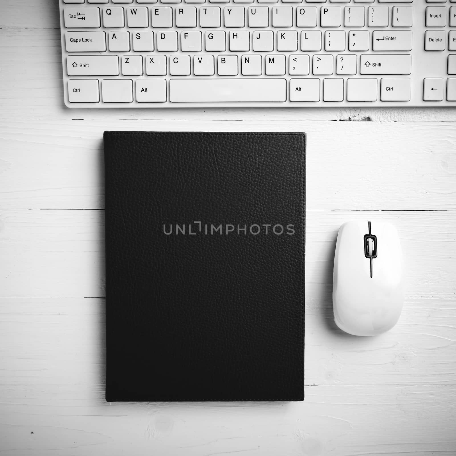 computer and brown notebook with office supplies black and white by ammza12