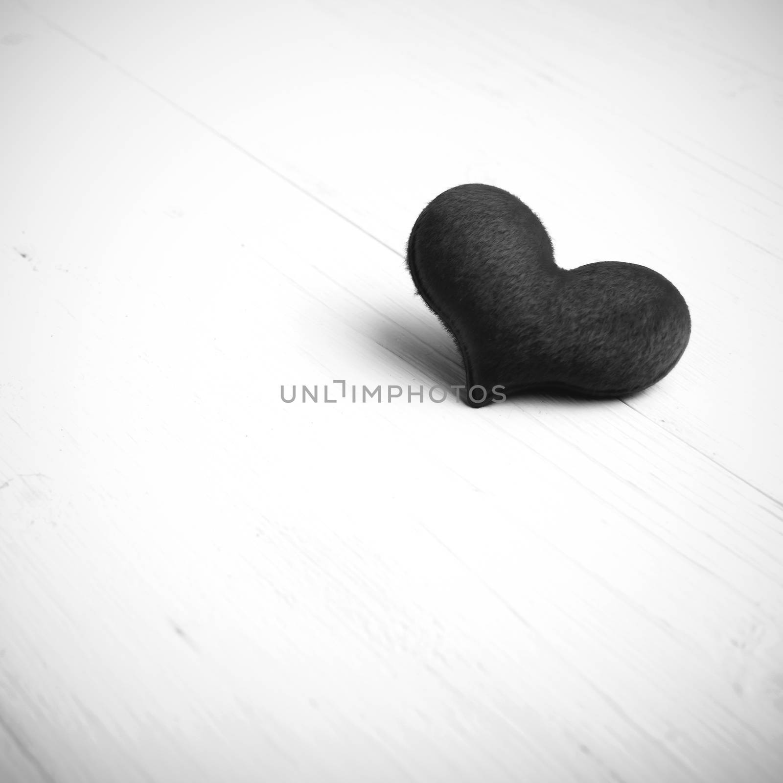 red heart on white table black and white style