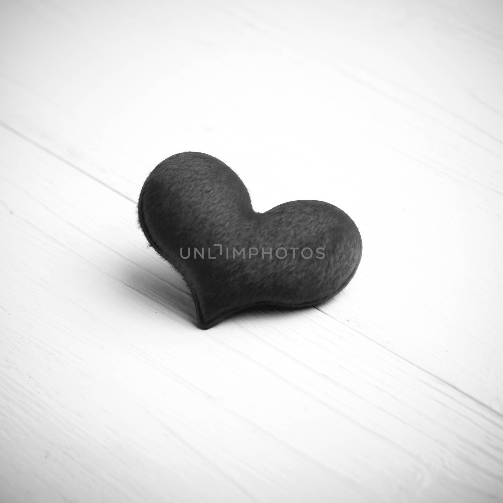 red heart on white table black and white style