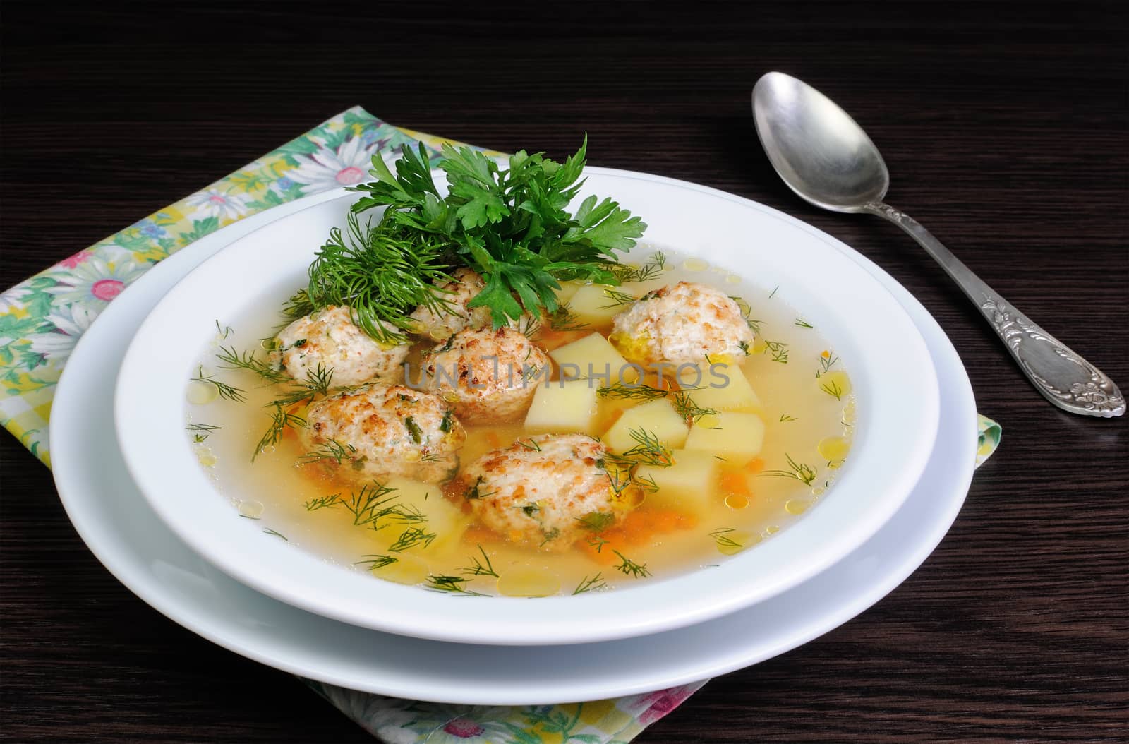 chicken broth of potatoes, carrots and meatballs sprinkled with dill