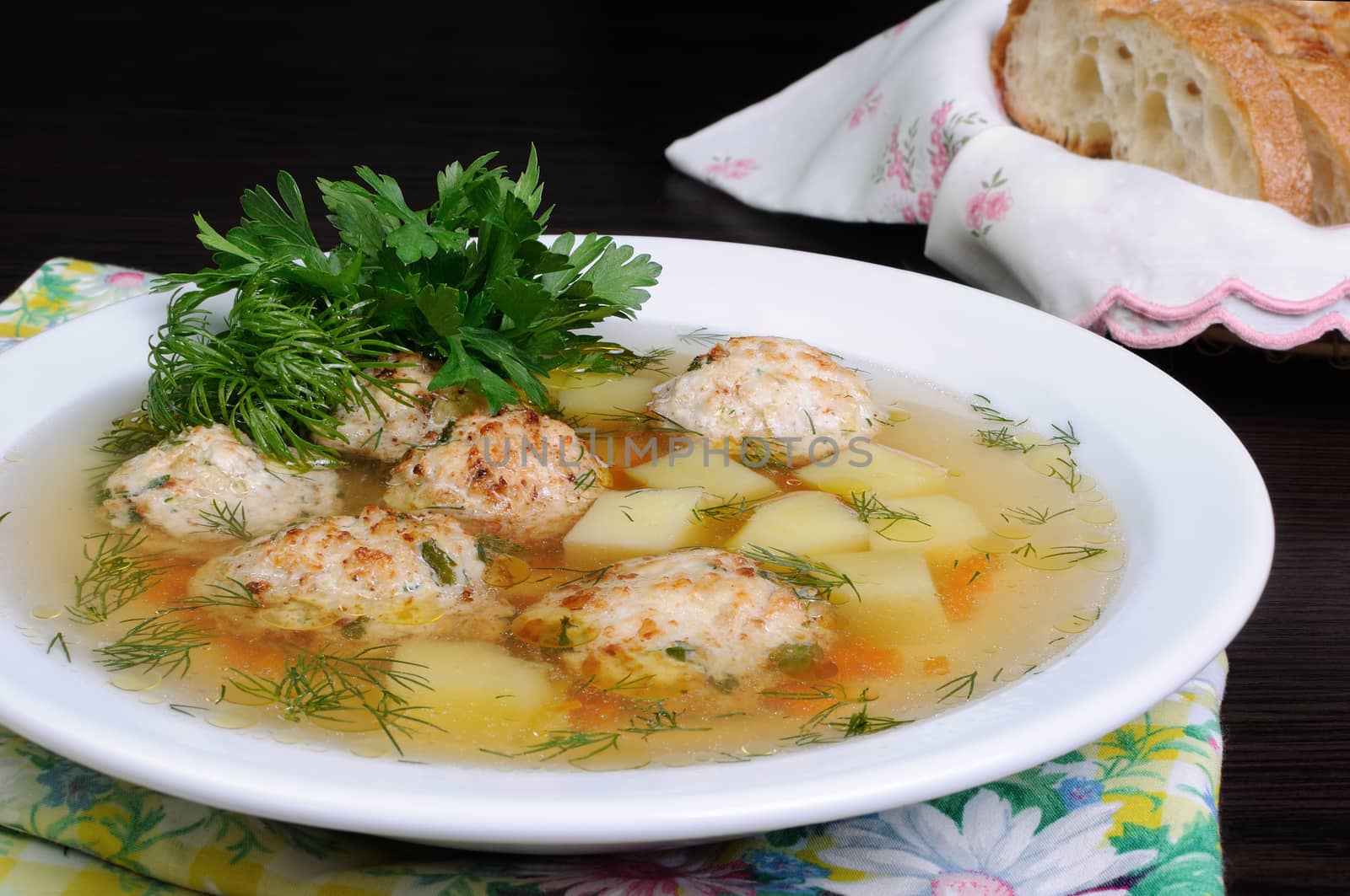 chicken broth of potatoes, carrots and meatballs sprinkled with dill