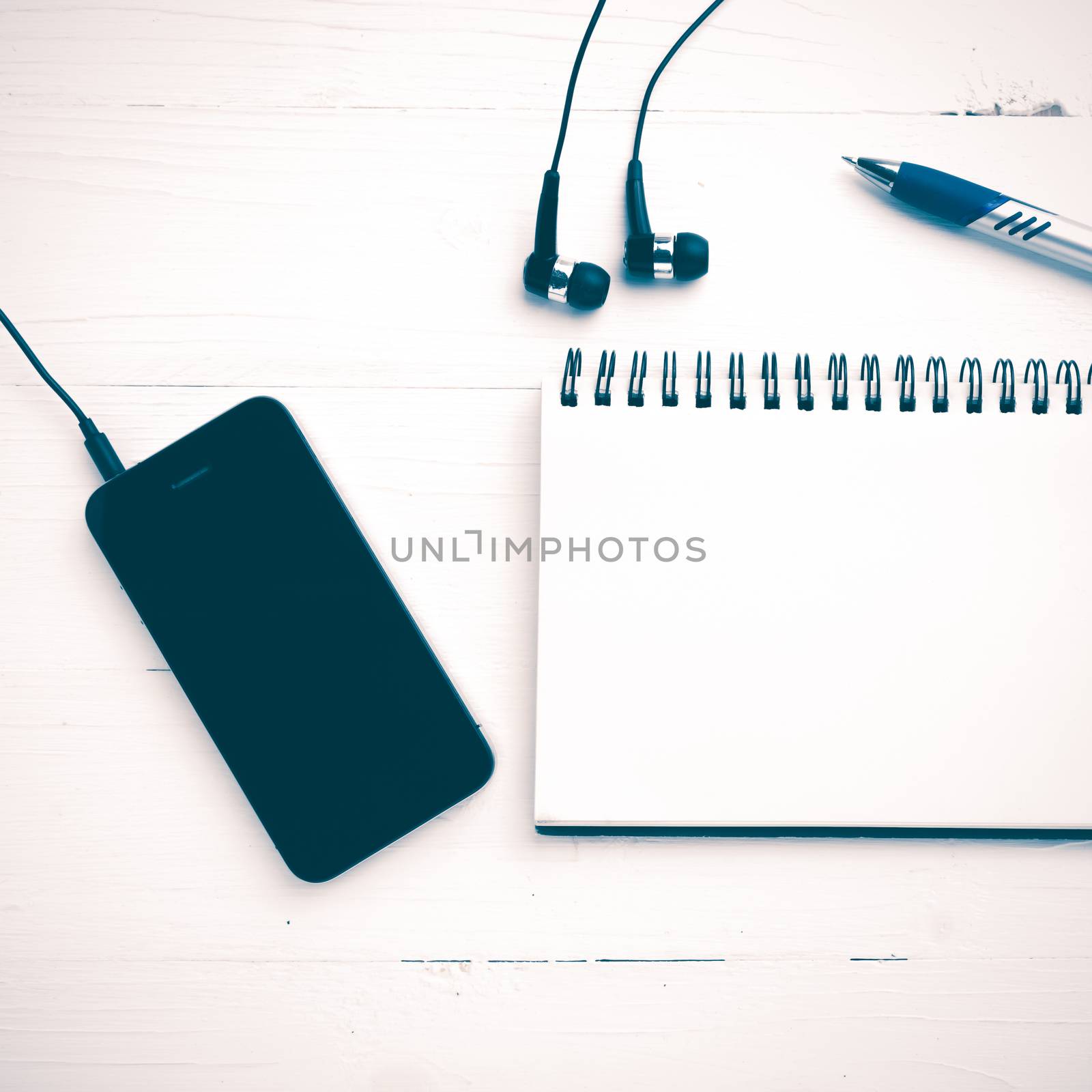 notepad and cellphone over white table vintage style