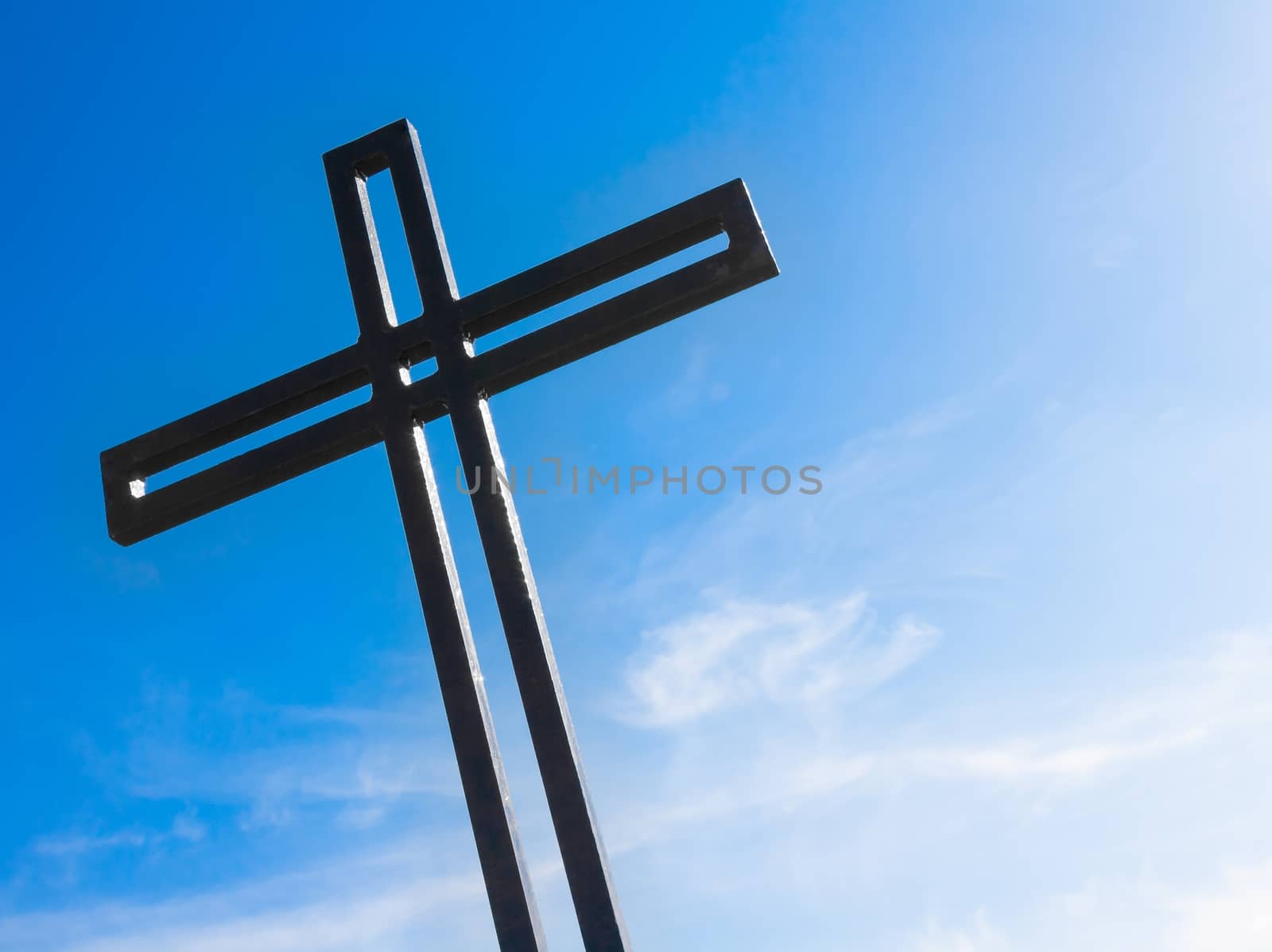 cross against the blue sky by donfiore